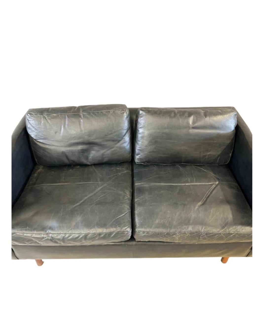 Mid century modern beautiful Black leather 2 seat loveseat sofa with walnut legs. Beautiful Black leather that shows little signs of use but broken in nicely. Great small deep leather sofa with Down filled cushions. Great vintage condition. Sofa is