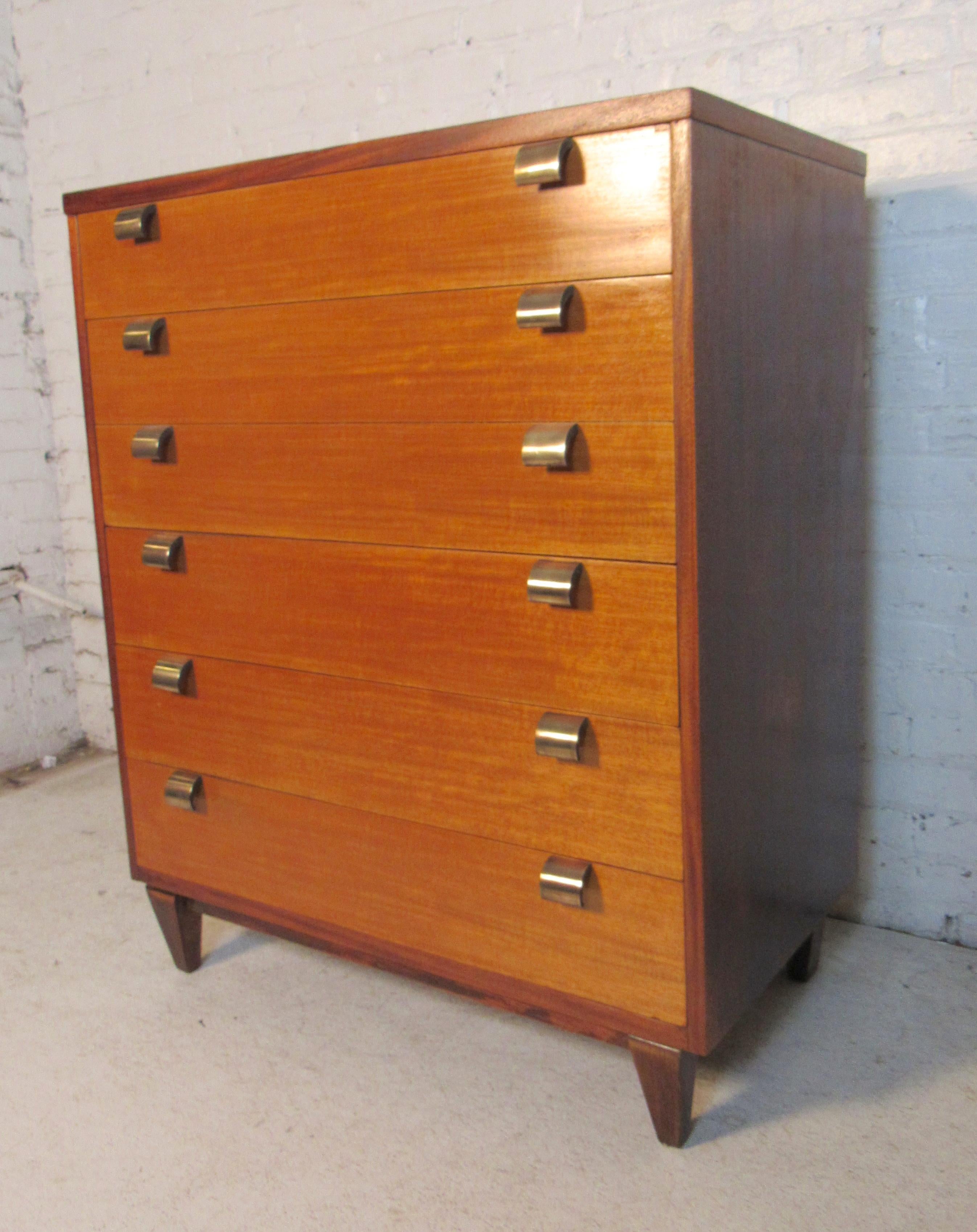 Unique two-tone wood finish is complemented wonderfully with tapered legs and stylish brass handles. Dividers split up the pairs spacious storage drawers making this an impressive vintage pair for any interior. Please confirm the item location (NY