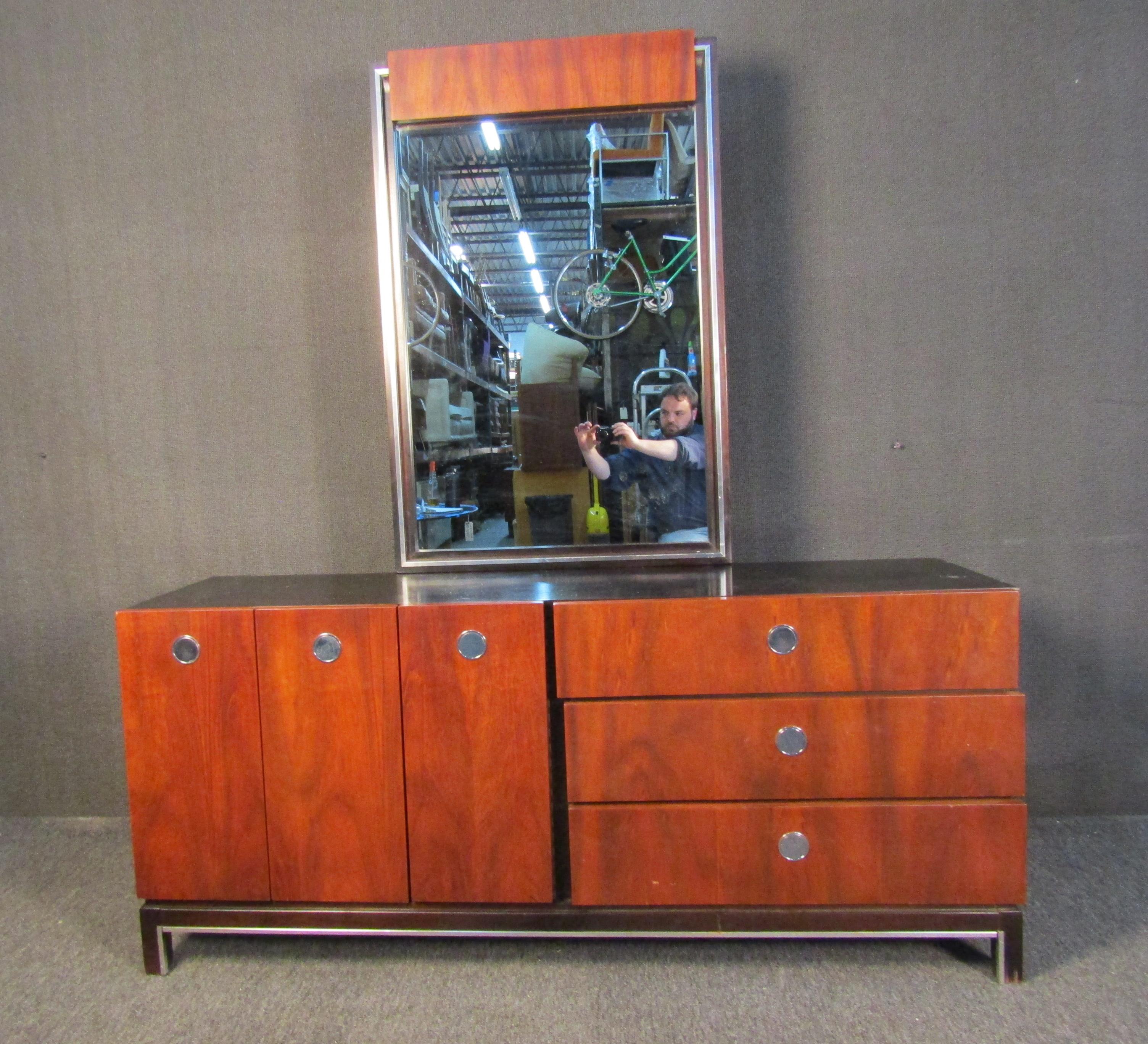 A gorgeous bedroom set that includes a dresser with mirror, highboy dresser, and small dresser. Rich walnut woodgrain is complemented by black sides and tops, along with circular metal handles. Please confirm item location with seller