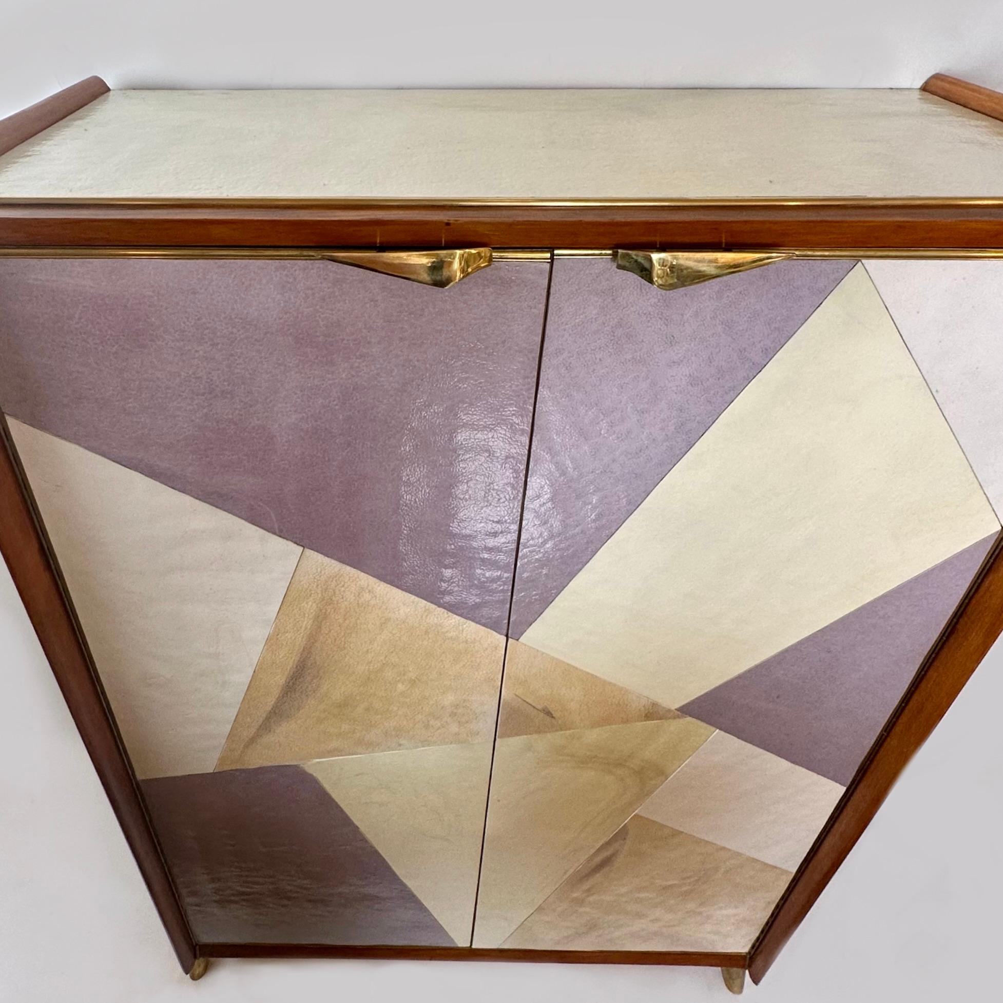 Splendido mobile bar a due ante con tre ripiani interni (93 x 31 cm. ciascuno) rivestiti con specchi bronzati e dettagli in ottone. Diversi colori (viola, avorio e beige) di vetro artistico di Murano testurizzato (simile alla pelle di mucca)