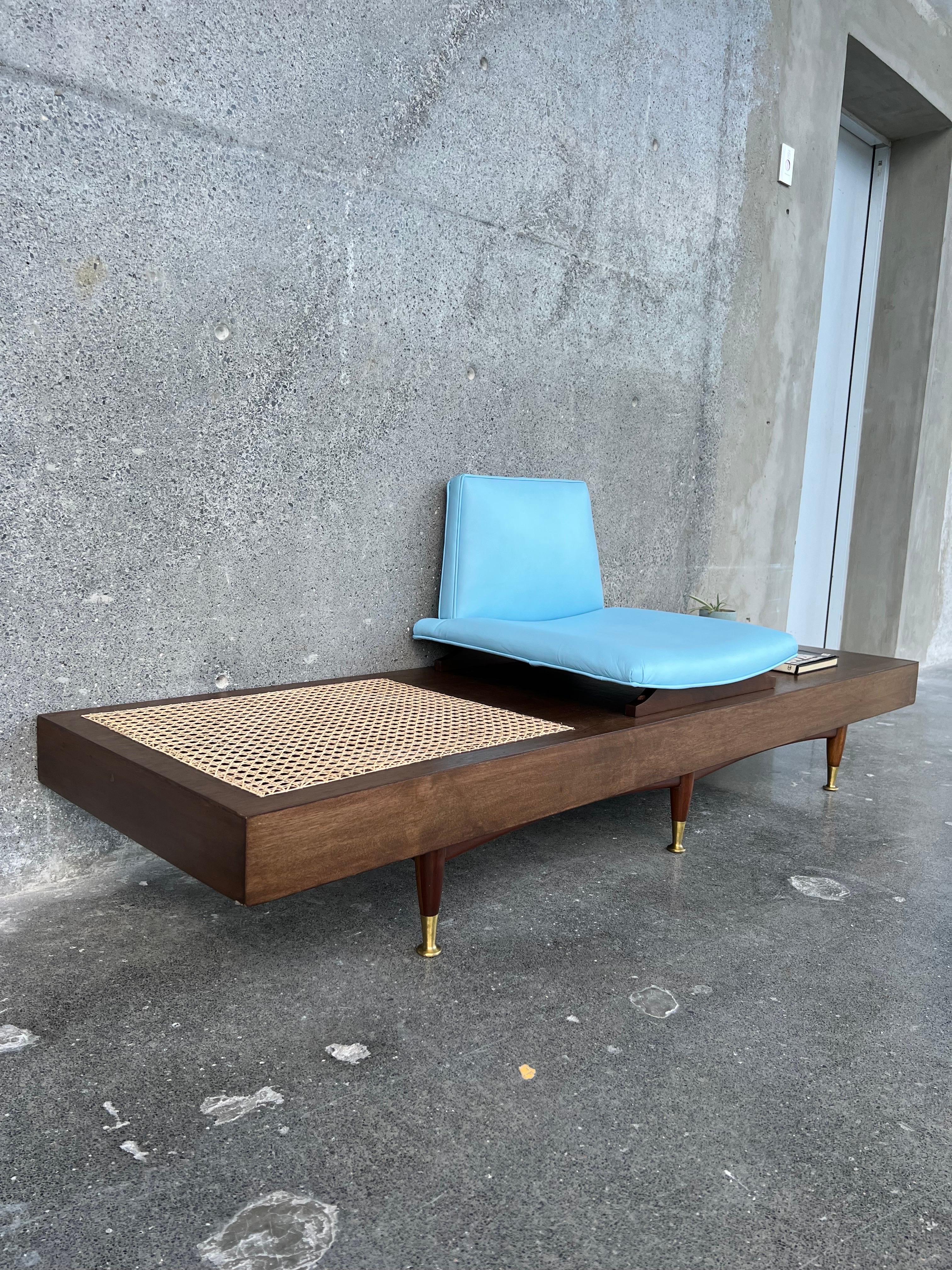 Perfect combination of design and materials, goat leather, handmade cane, brass, solid wood and veneer. Possibly the design was conceived as a telephone bench for having only one seat. It is a beautiful piece that exalts our gallery and that