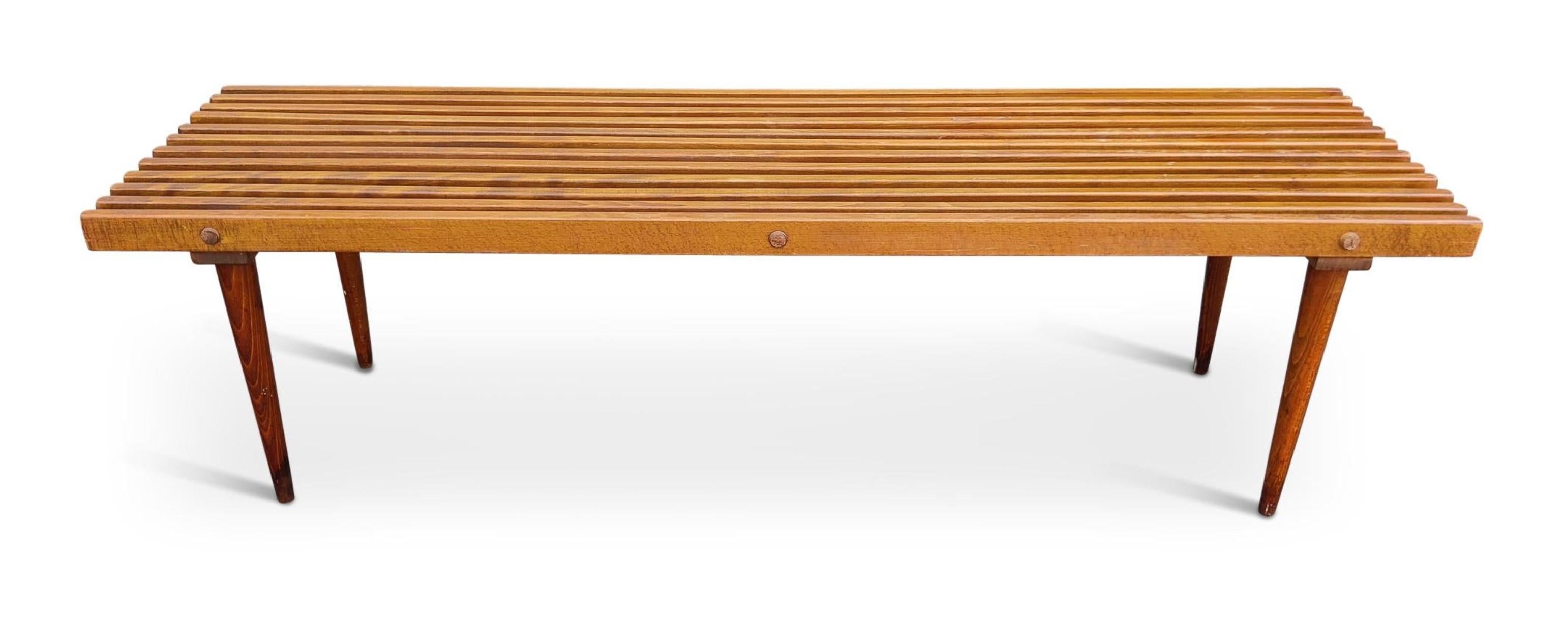 Mid-century slatted bench, cocktail table from the mid-1950s. Faintly stamped Yugoslavia on the underside - too faint to be photographed. Created out of a hardwood, beech, this piece is simple and well constructed. Legs unscrew for easy transport