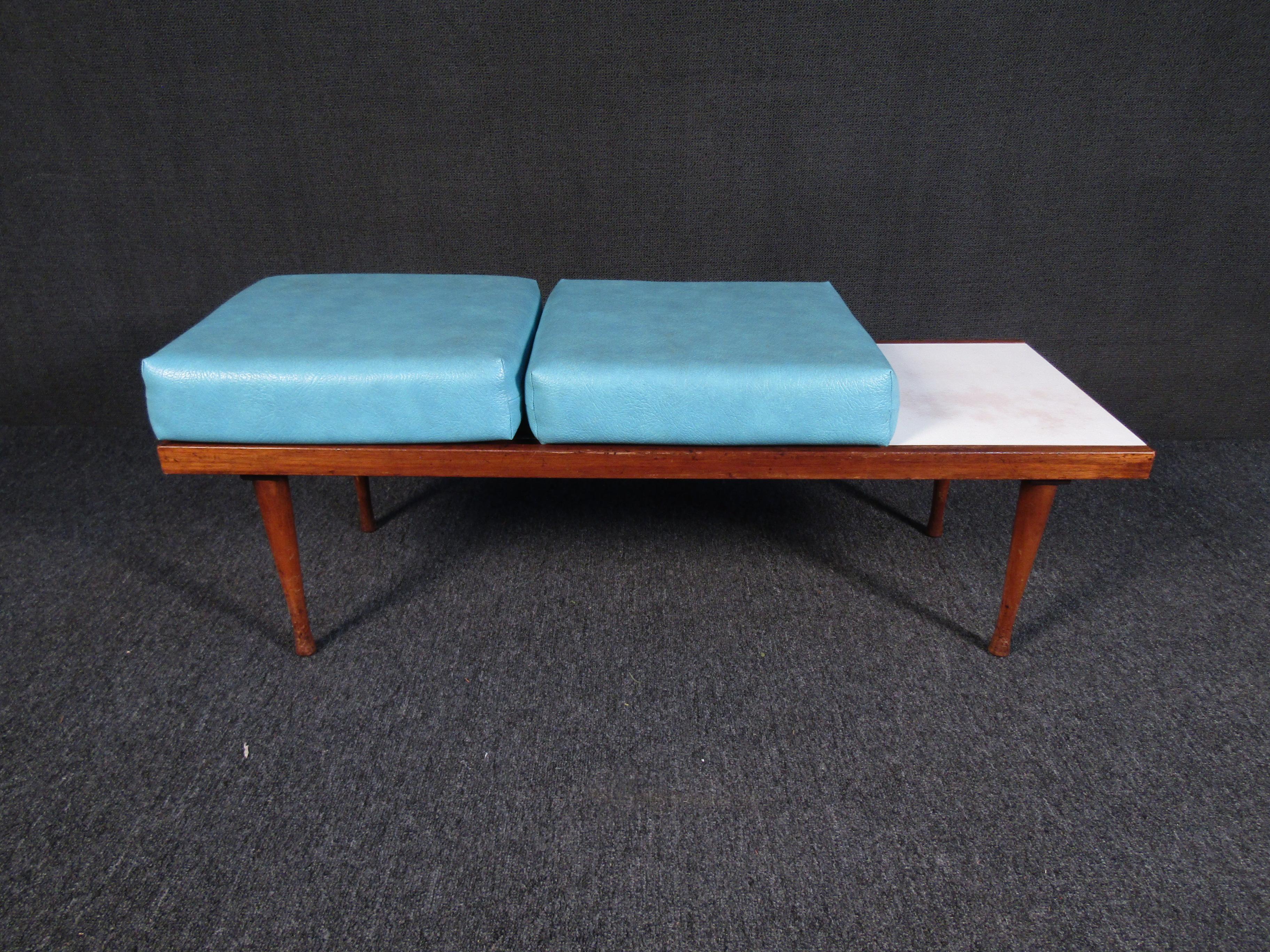 An interesting vintage bench combining sculpted walnut legs and a slatted top with cushions upholstered in a vibrant blue upholstery. One side of the bench also has a white cover to set items on. Please confirm item location with seller (NY/NJ).