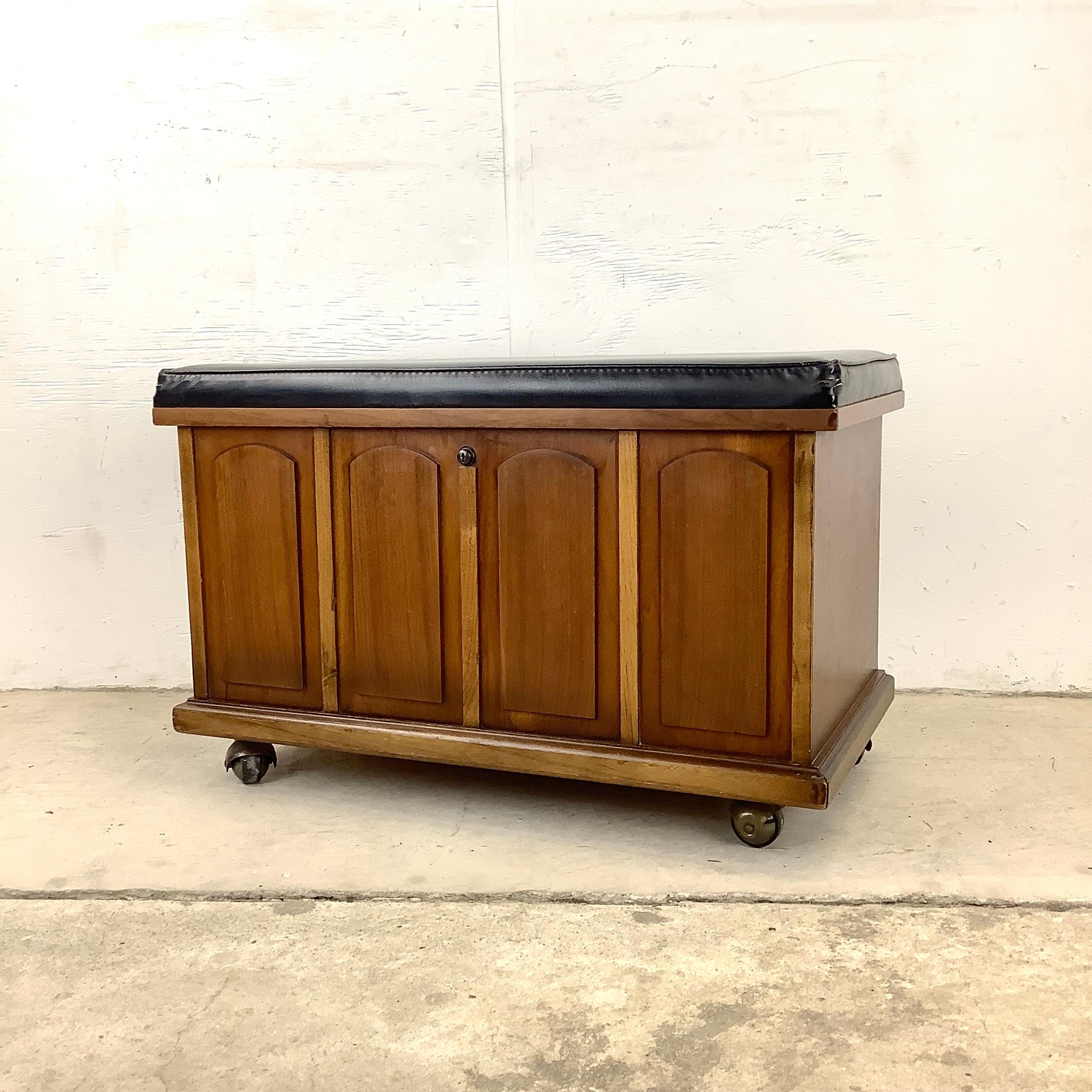 This stylish midcentury walnut storage bench features a vintage wood finish, vinyl top with interior record storage, and simple modern lines. The interior dividers also have removable shelves for extra versatility. Quality design from Lane Furniture