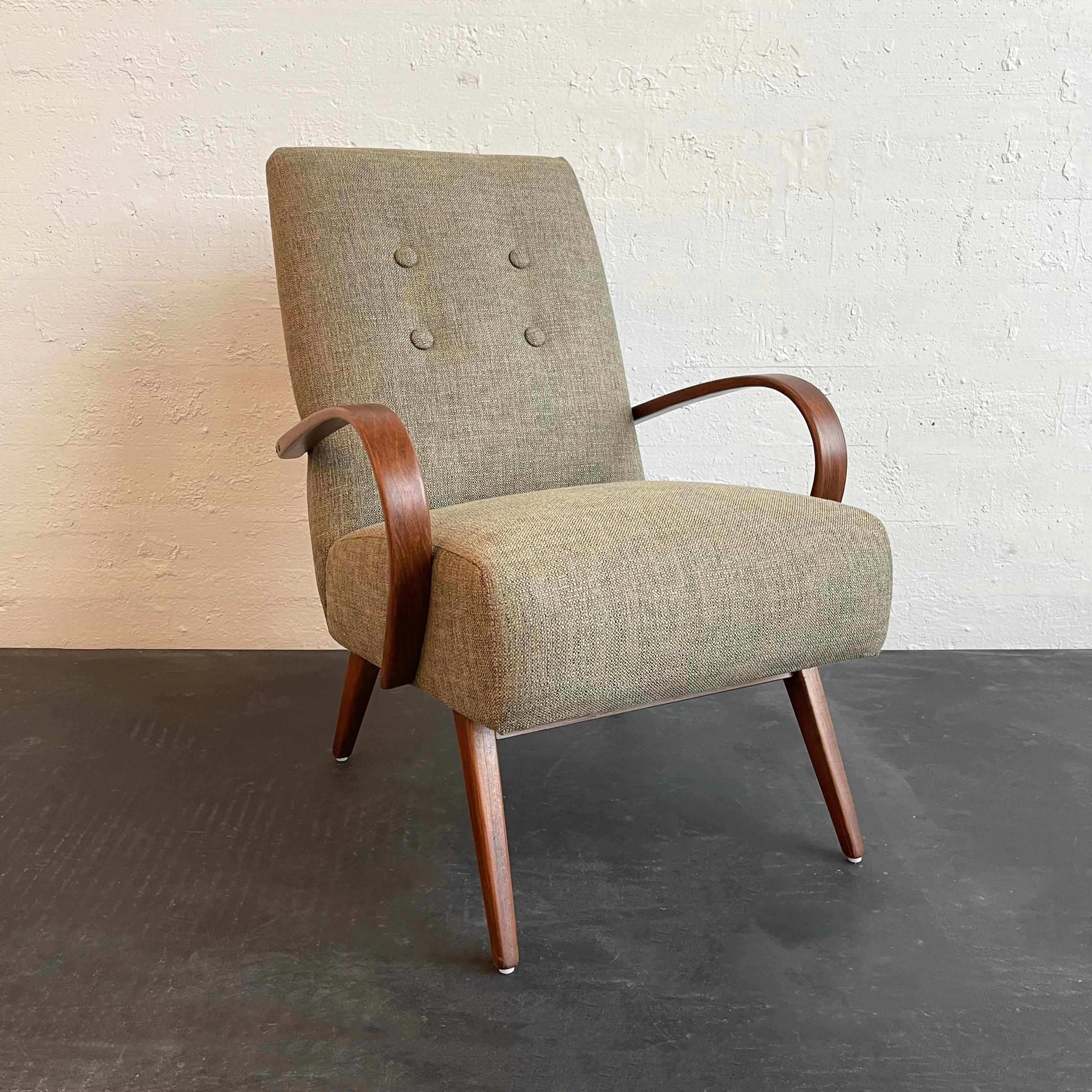 Bentwood armchair designed by Czech furniture designer Jaroslav Smidek for Ton features a bent beech wood frame and muted blue green tweed upholstery. 

Smidek learned furniture design from his father while working in the family workshop. He