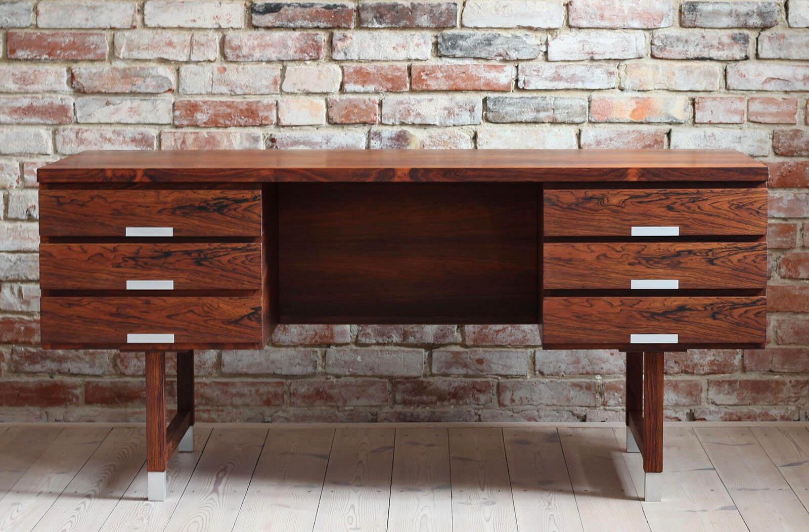 This stunning vintage desk is a fantastic example of Kai Kristiansen style, one of the most-appreciated Danish designers of 20th Century. Pure in form yet very effective. Produced by Feldballes Møbelfabrik with highest care to every detail. The desk