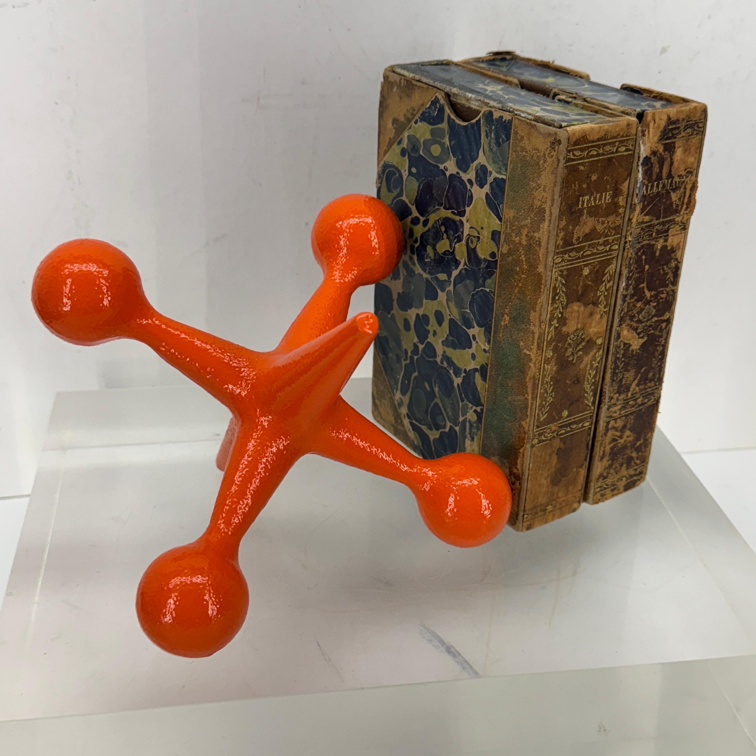 Mid-Century Modern Jax bookend or doorstop by Bill Curry for Design Line. This Jack bookend is made of heavy cast iron with a stunning bright orange powder coat that gives character.
 