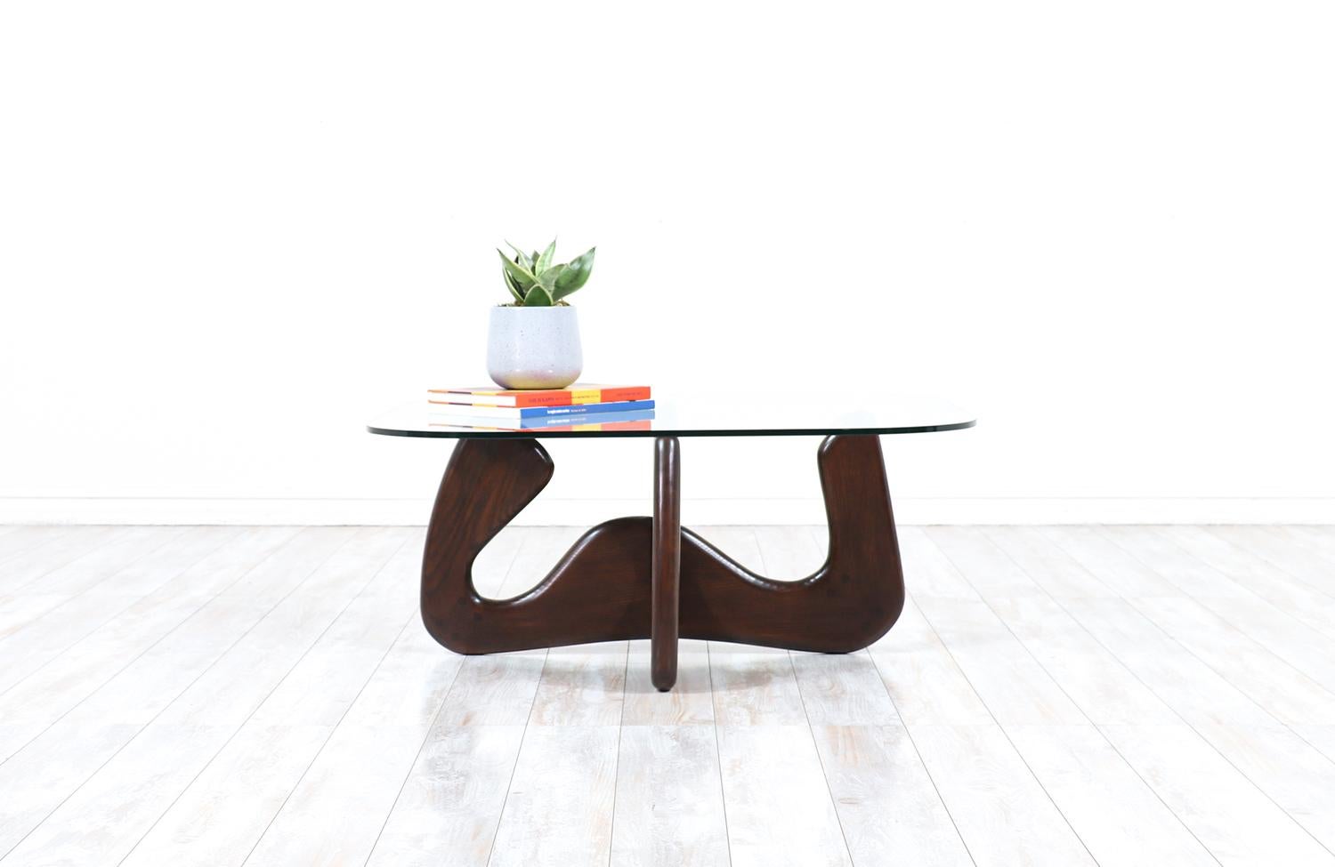 Mid-Century Modern biomorphic coffee table with glass top.