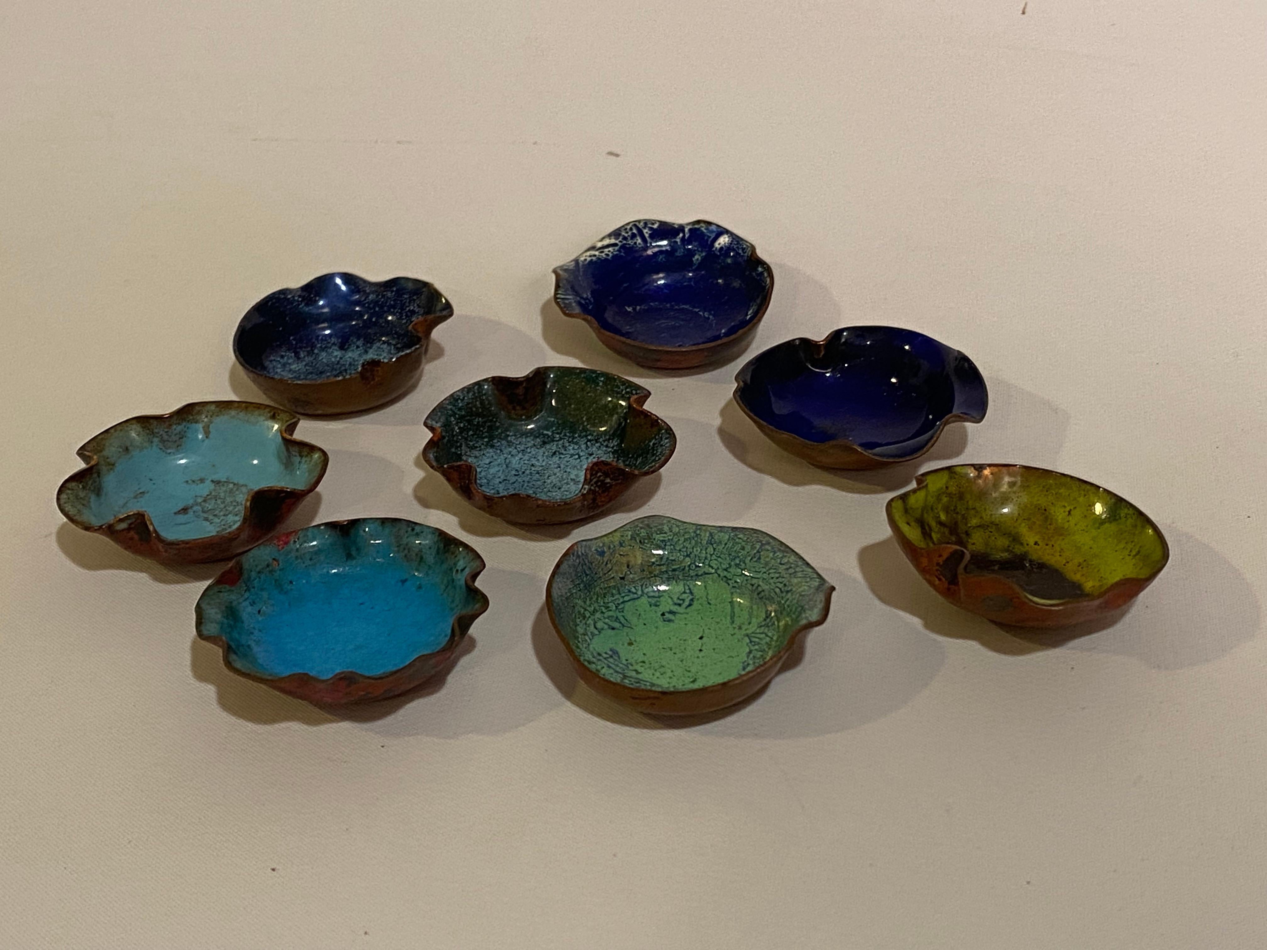 Set of eight fine Mid Century Modern biomorphic enamel on copper salts. Very distinct set of crimped and crinkled enameled salts. Circa 1965. Enameling became a huge crafts movement in the 1960s. There are so many wonderful visual and tactile