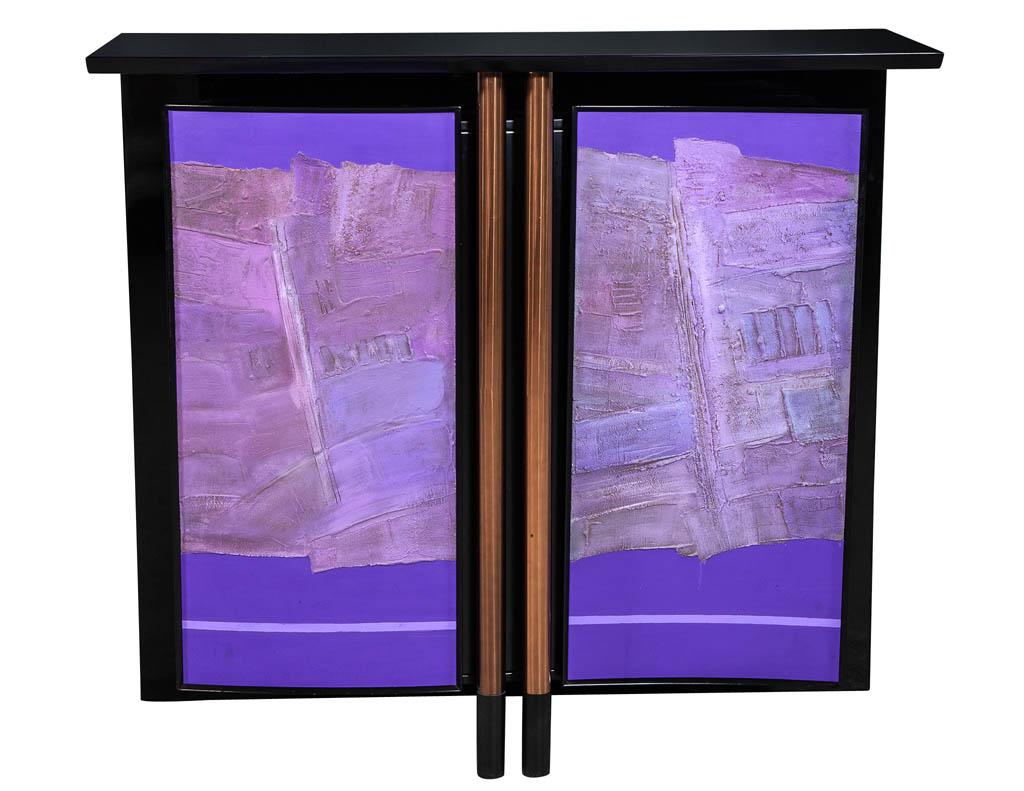 Mid-Century Modern ebonized black bar cabinet from New York City., Excellent original condition. Featuring two violet doors with glass shelves and sides. A truly unique, Mid-Century Modern design.

Price includes complimentary curb side delivery