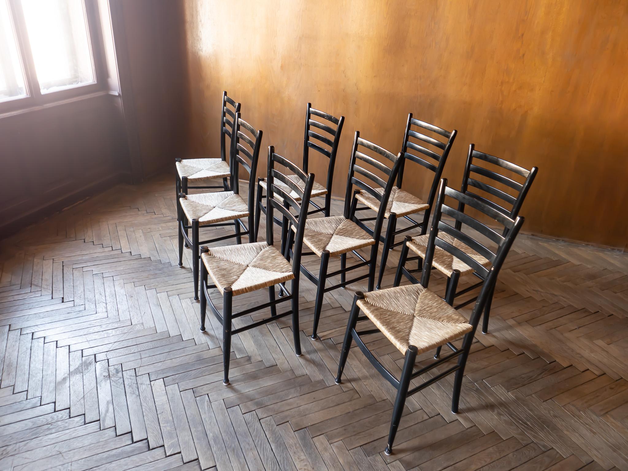 Mid-Century Modern black bast chiavari dining chairs, Italy 1960s.

This set of 8 wooden dining chairs was designed and produced by Italian furniture company Chiavari in the 1960’s. Each chair combines a black lacquered frame and bast seat. Due to