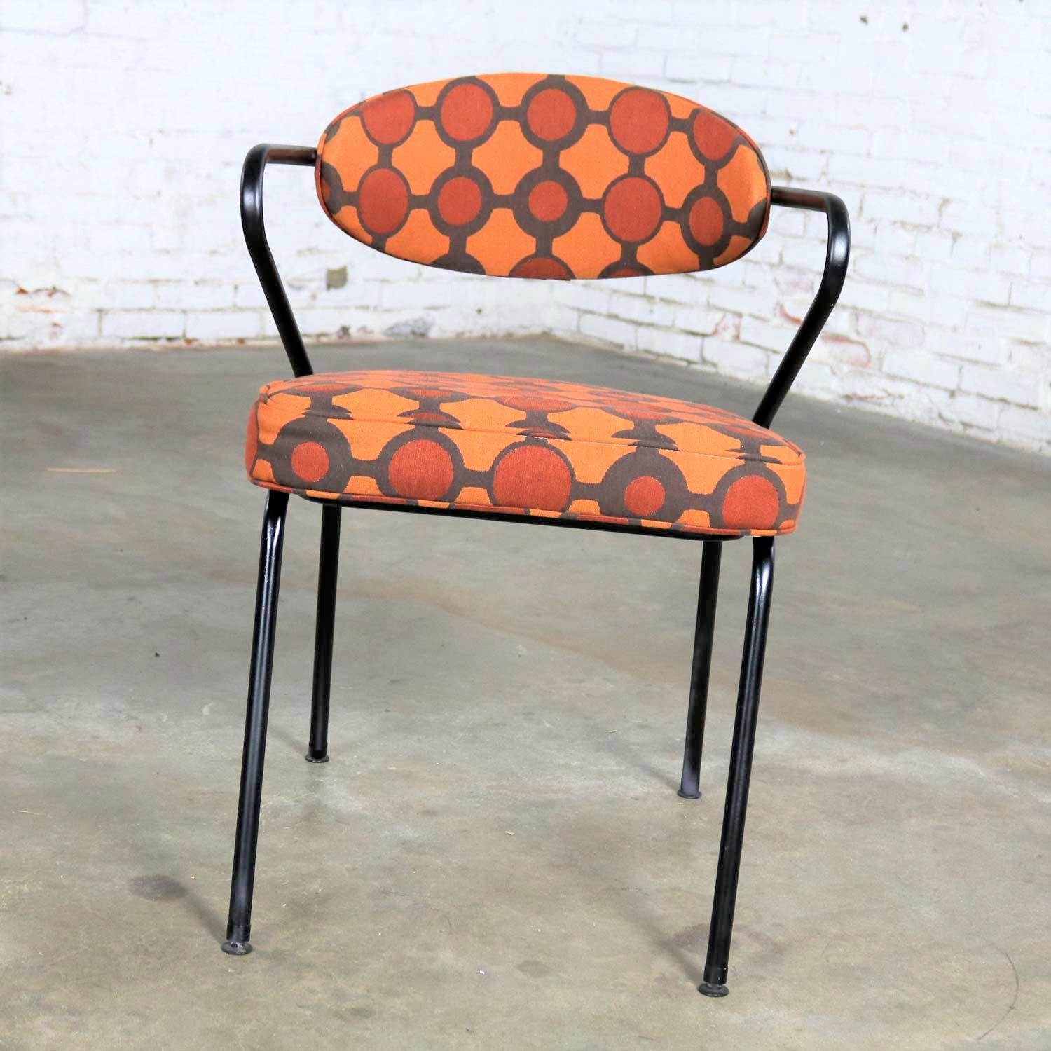 Handsome Mid-Century Modern armchair made of bent steel tube painted black and newly upholstered in an orange contemporary geometric fabric. It is in wonderful restored condition and ready to use. Please see photos, circa 1950s.

Sometimes you