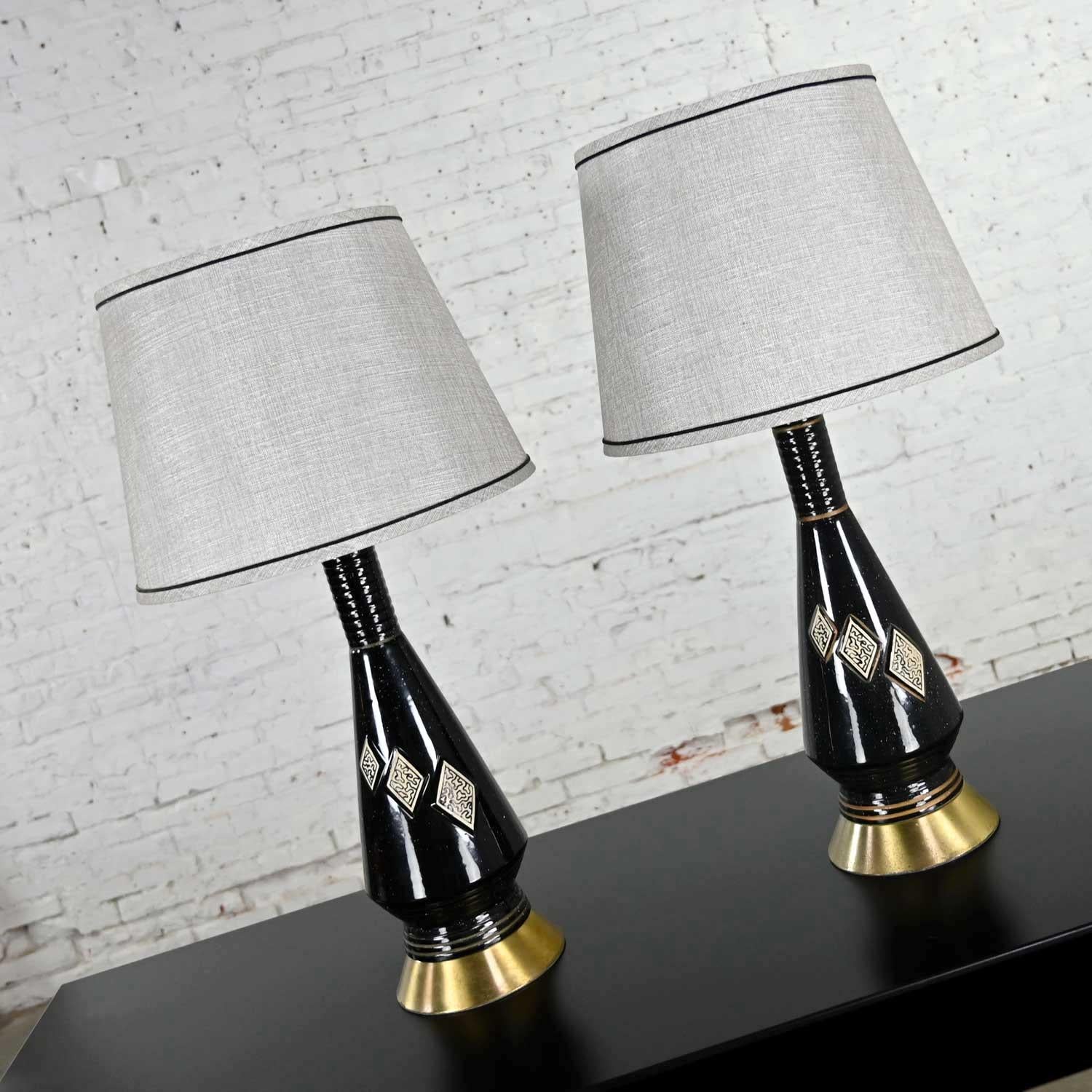 Wonderful Mid-Century Modern black ceramic lamps with harlequin diamond style designs on front and new gray tapered drum shades. Beautiful condition, keeping in mind that these are vintage and not new so will have signs of use and wear. All of the