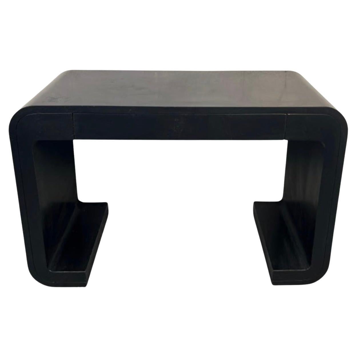 A mid-century modern console table wrapped in sleek black vinyl for a bold, streamlined look. The piece includes a convenient drawer for storage and features clean, minimalist lines that complement a variety of interiors. A stylish and functional