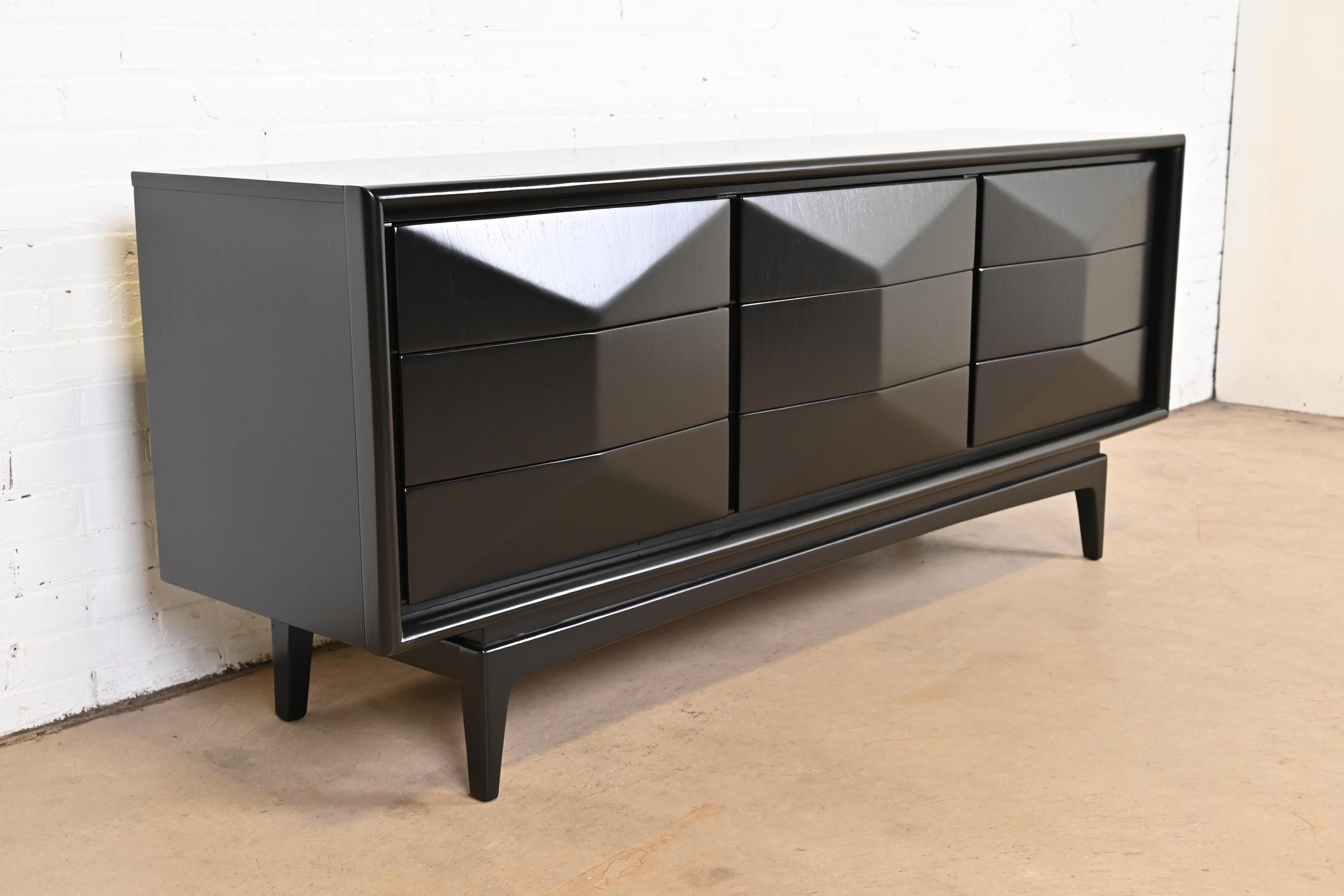 A stunning Mid-Century Modern black lacquered sculpted walnut diamond front long dresser or credenza.

By United Furniture Co.

USA, 1960s

Measures: 74.13