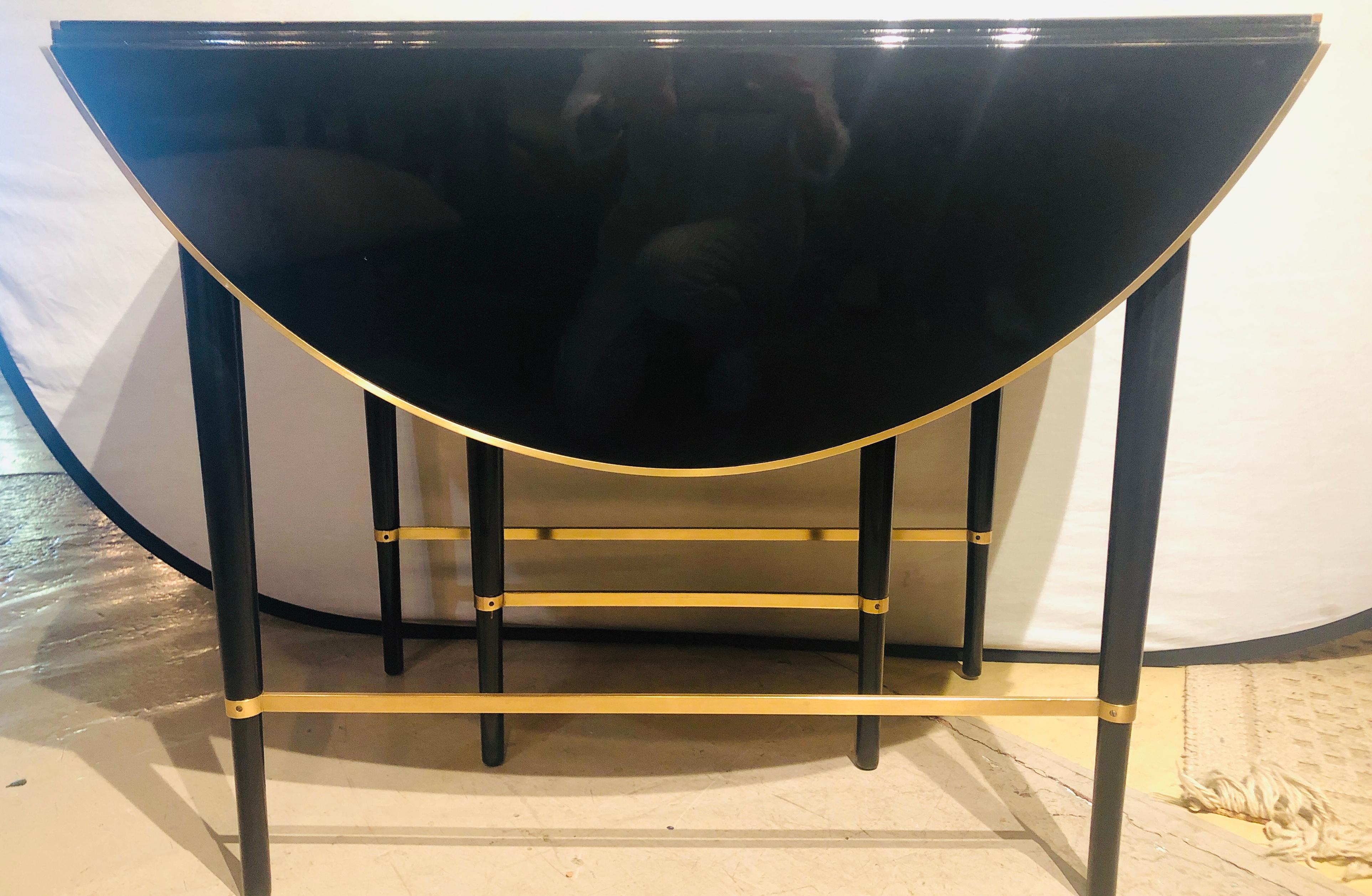 Mid-Century Modern black lacquered Paul McCobb serving / dining table with 5 leaves. This stunningly finished dining, center, card or serving table would turn any small Manhattan apartment into a dining venue. The sleek and clean lines with heavy