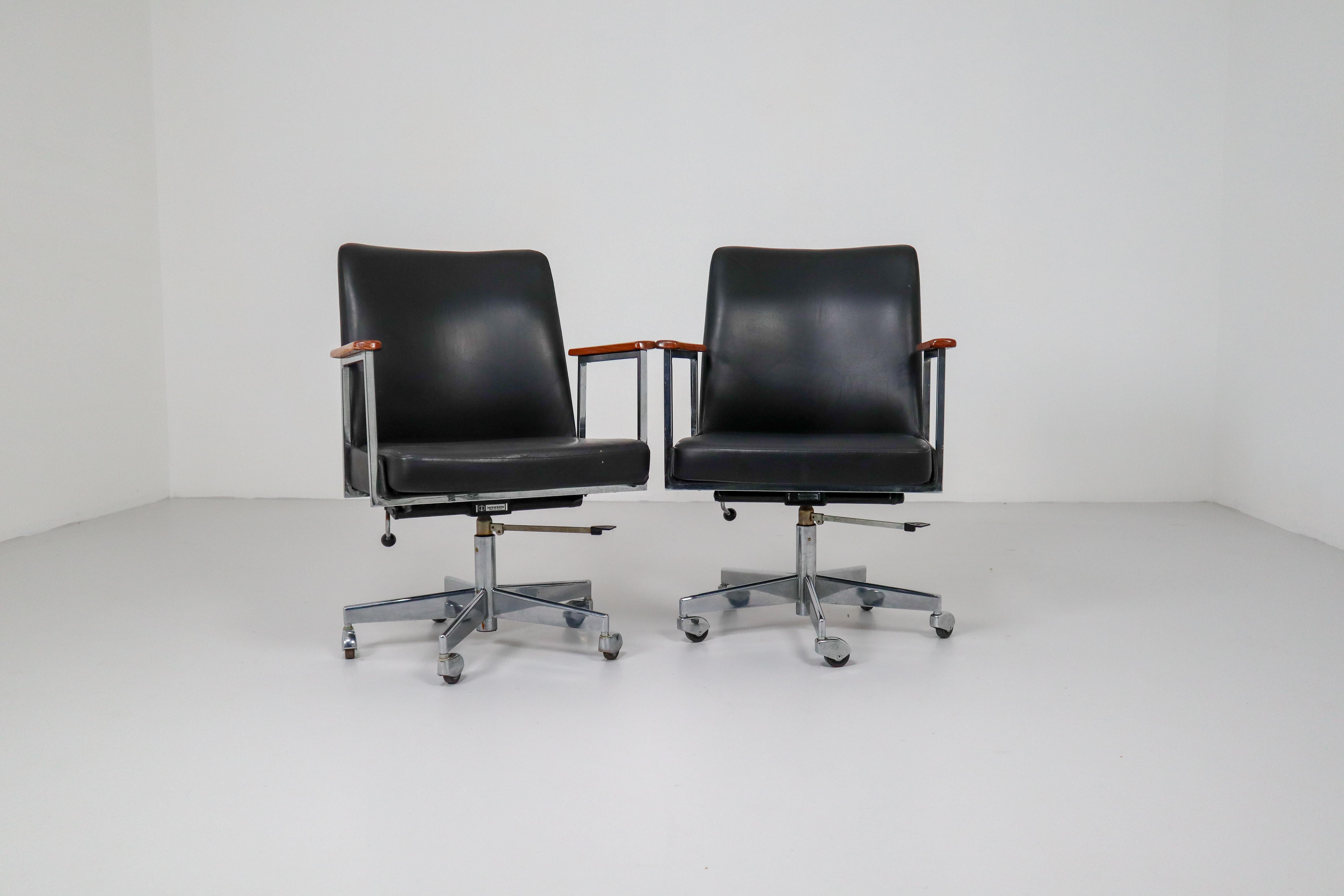 Mid-Century Modern black leather office armchair was manufactured by Mauser. The chair is in original condition. Seat and back are covered with black leather, armrests are made of lacquered wood.
   