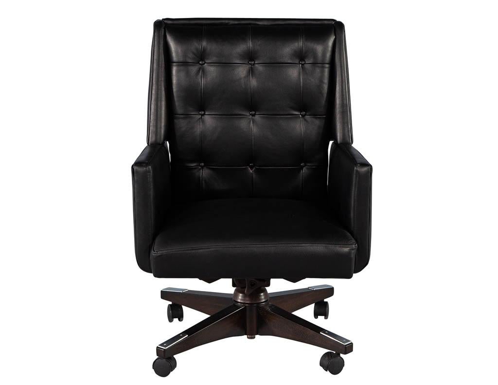 Mid-Century Modern leather office chair. America, circa 1970s. Restored in all new black Italian leather with beautiful tufted design. Completed with a rich dark walnut base on castors with stainless steel accents. Chair is not adjustable. Price