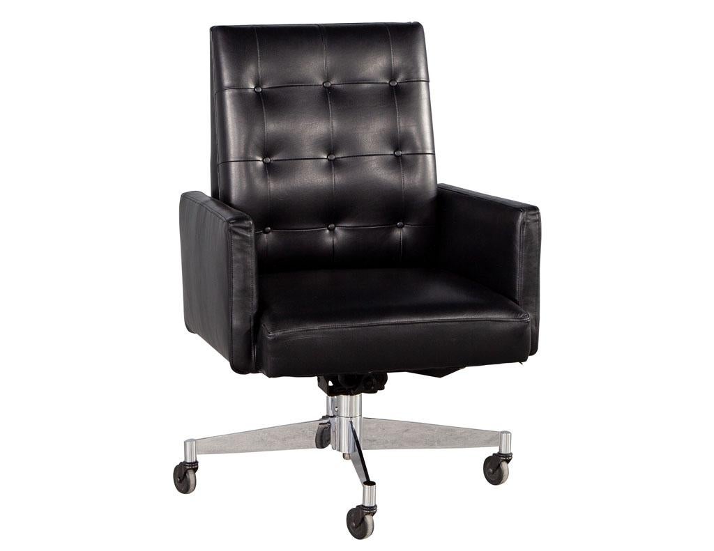 Mid-Century Modern black leather swivel office chair by Stow and Davis. Iconic mid-century modern office chair design newly upholstered in black Italian leather with beautiful, tufted back detailing. Base frame is composed of stainless-steel metal.