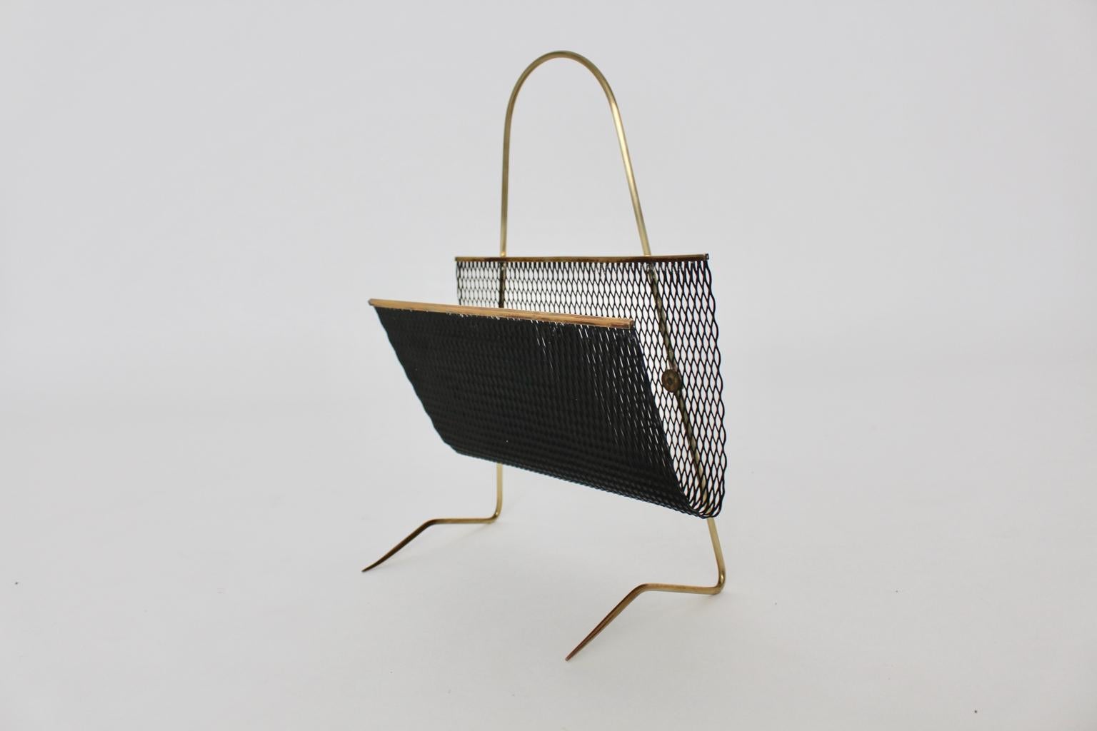 This presented vintage magazine rack in the style of Mathieu Mategot stands out through its extraordinary structure. Also the magazine basket of the magazine rack was made of black lacquered perforated metal and the feet were made of brass.
Very