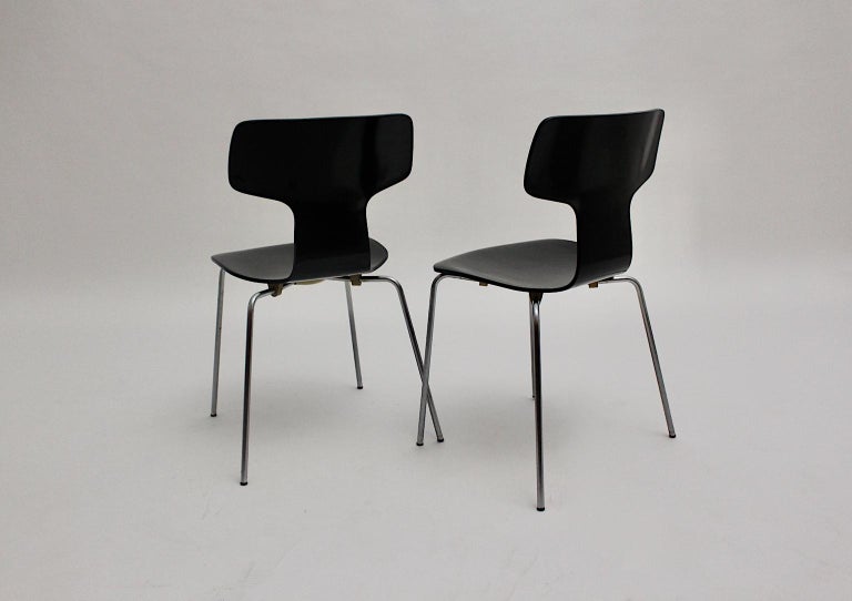 Scandinavian Modern set of 2 vintage black stairs, which was designed by Arne Jacobsen 1952 and executed for Fitz Hansen, 1970, Denmark. It is marked underneath.
The stacking chairs were made of a tube steel base, while the seat and back were made