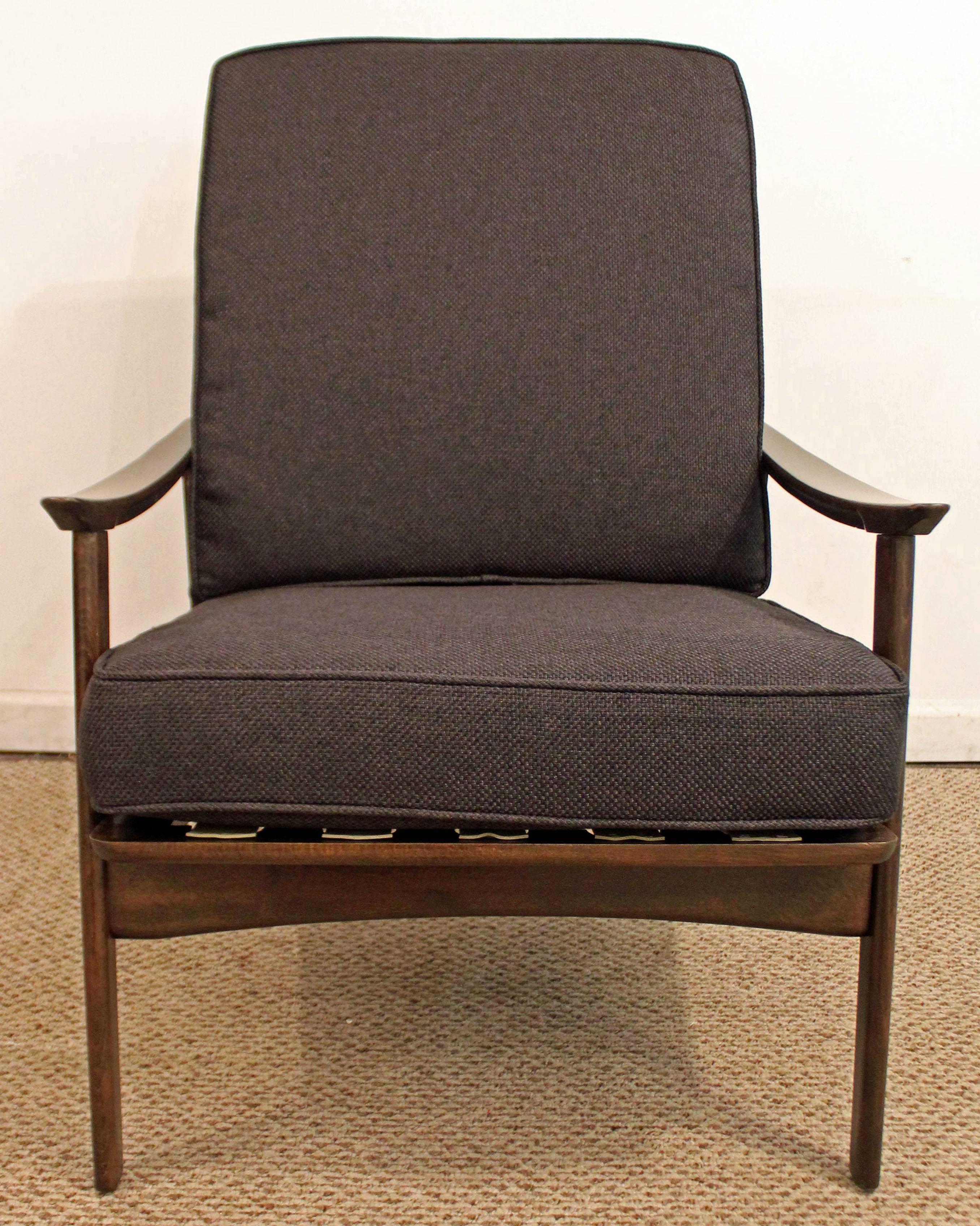 This walnut lounge chair has been completely redone; refinished, restrapped, recushioned, and reupholstered with black fabric.