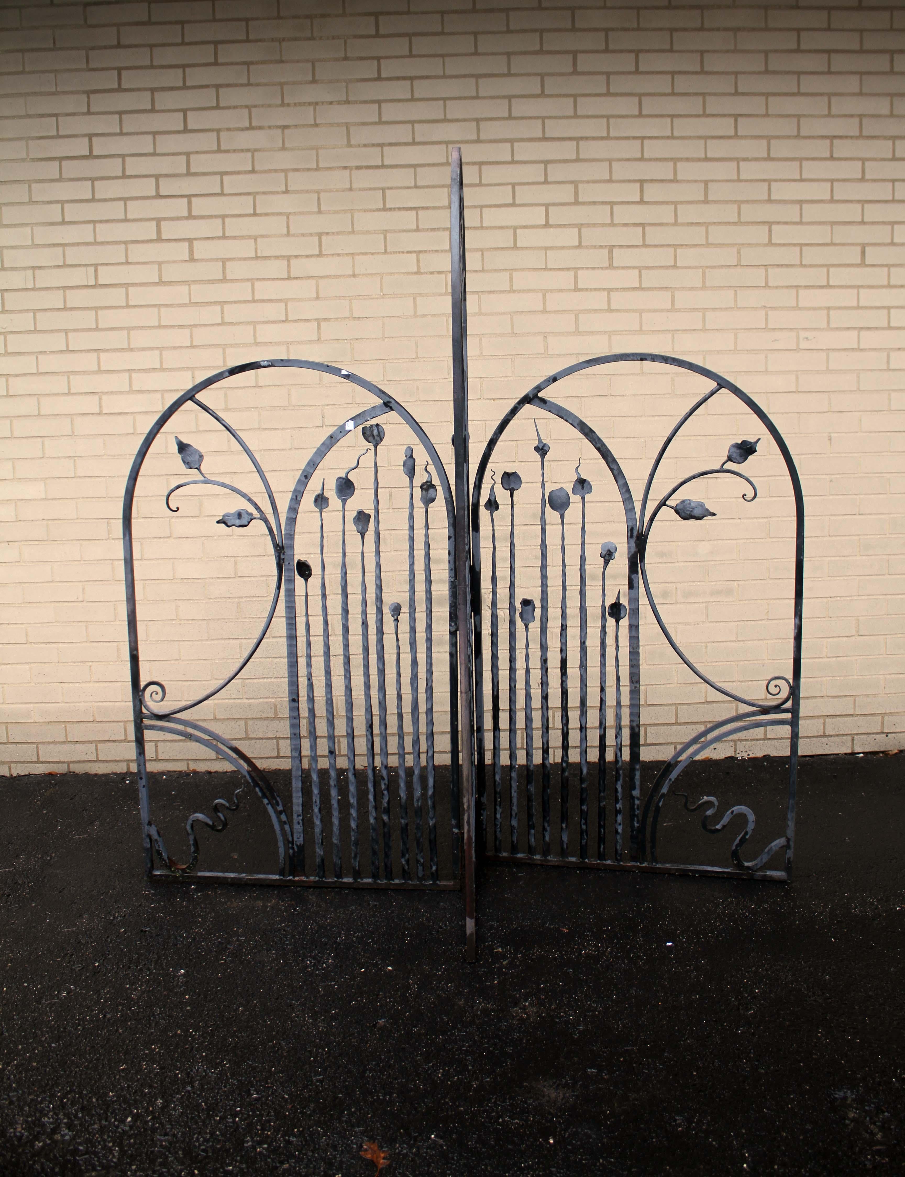 This black outdoor gate sculpture is a unique and eye-catching piece of art. Crafted from wrought iron, this piece of outdoor decor adds an elegant yet modern touch to any garden or outdoor space. The intricate design of the gate creates a
