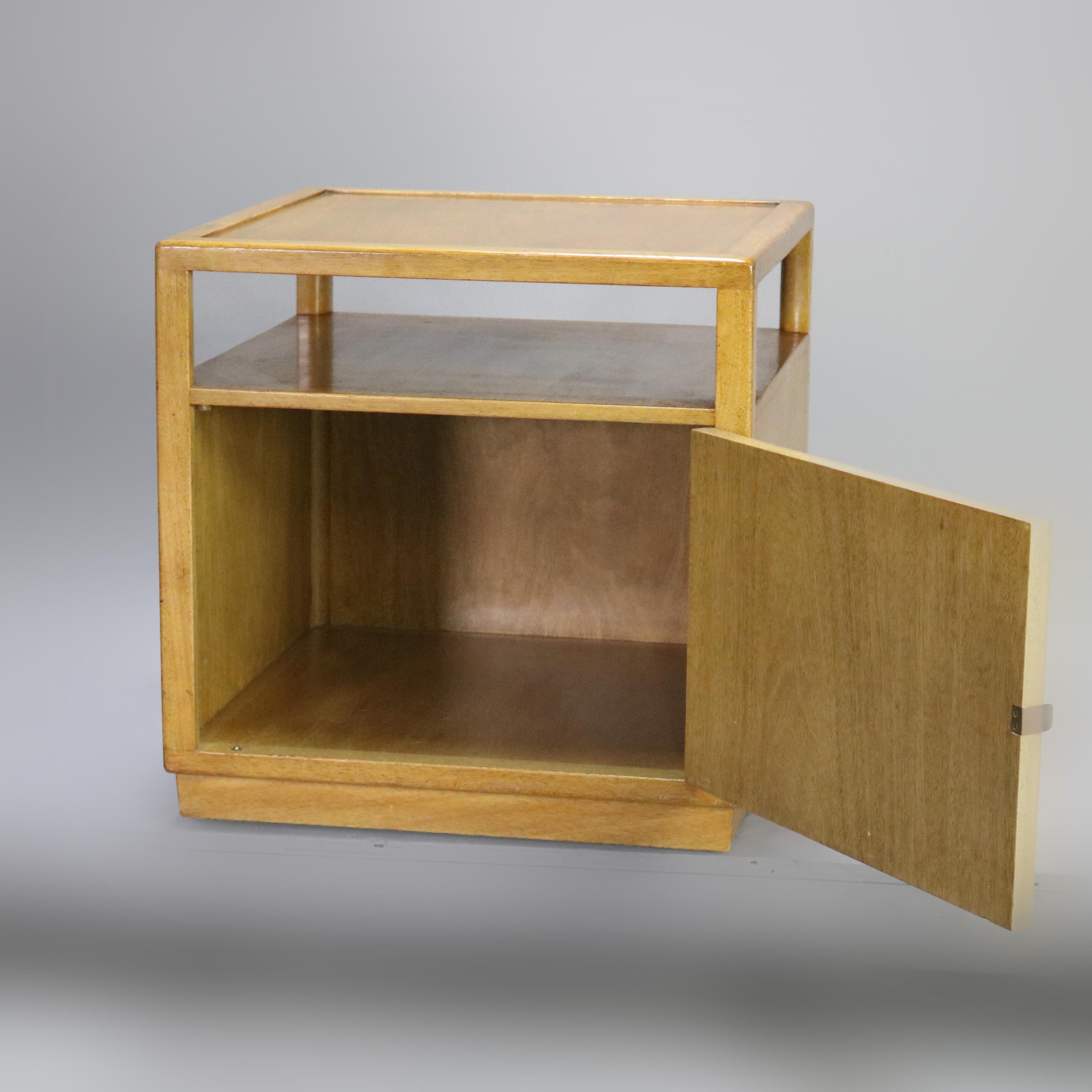 A Mid-Century Modern side stand by Dunbar offers bleached mahogany construction with elevated top surmounting lower cabinet, 20th century

***DELIVERY NOTICE – Due to COVID-19 we are employing NO-CONTACT PRACTICES in the transfer of purchased items.