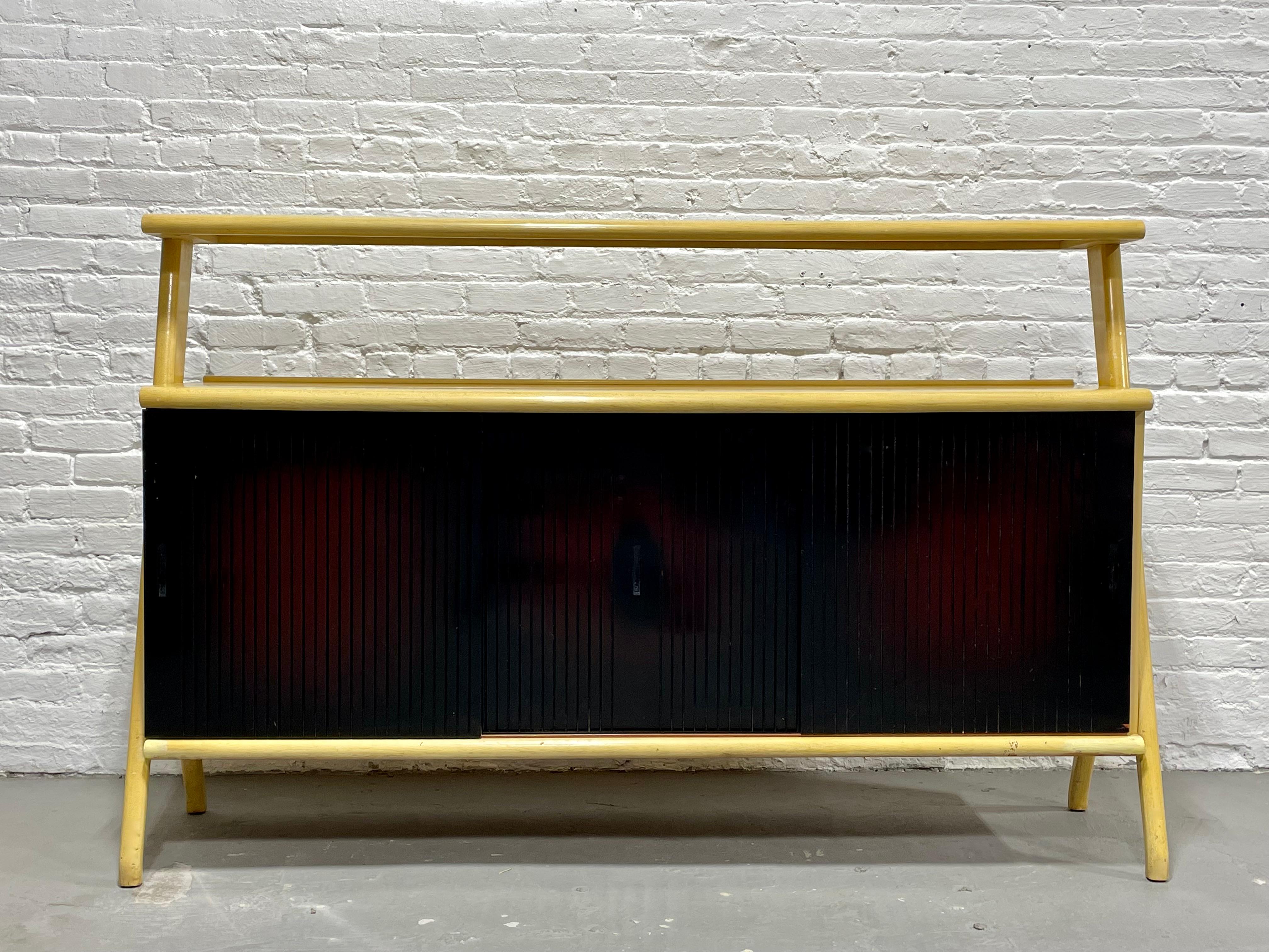 Mid-Century Modern sideboard in the style of Ico Parisi, circa 1960s. This monumental piece is gorgeous in its simple yet extremely functional design. The highlight of the piece is the unique forked leg design on either side. The piece is
