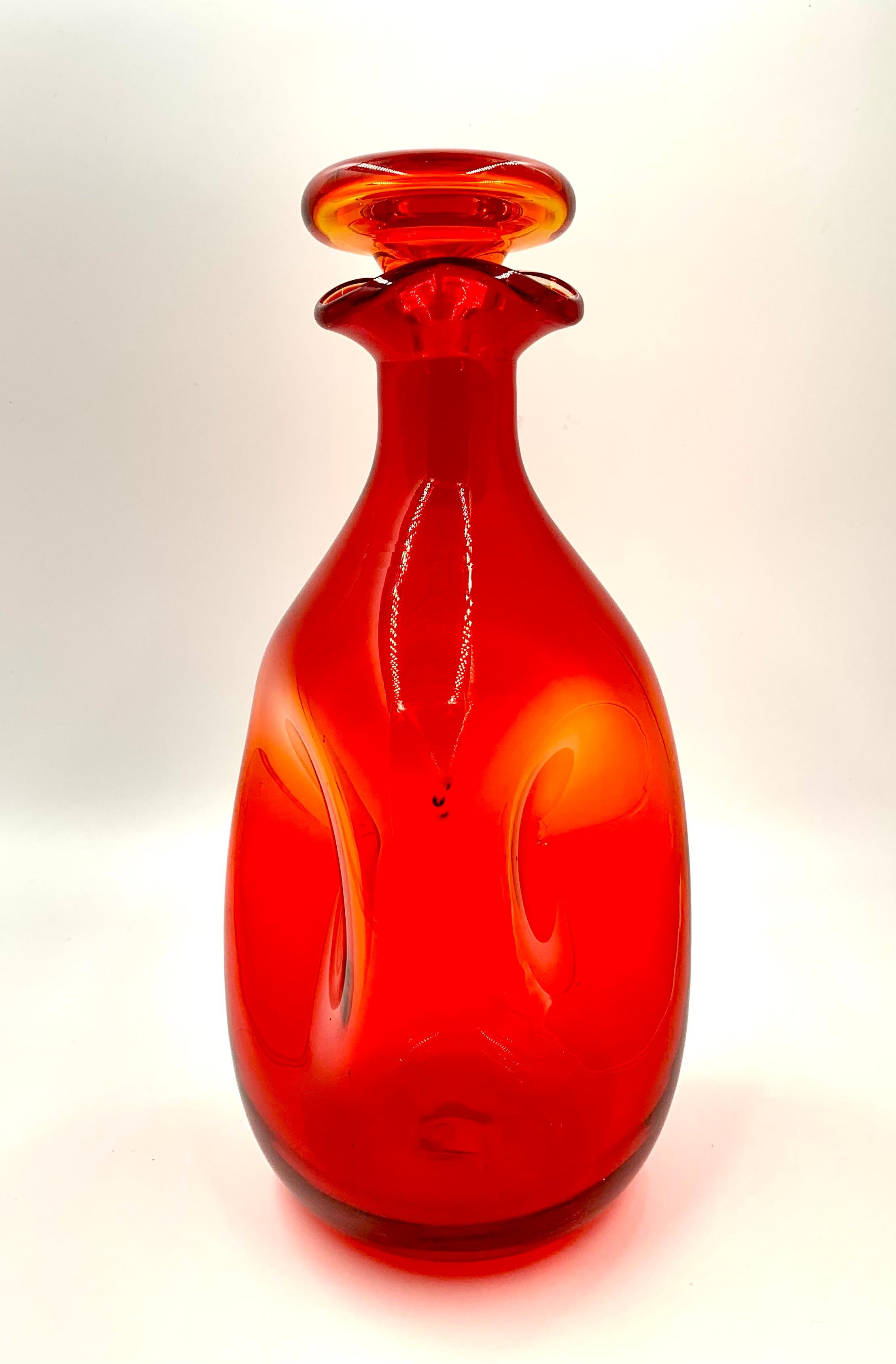 Vibrant vintage MCM tangerine Blenko art glass decanter.
Designed by Winslow Anderson, 1970's.
Very good condition
Hand blown intense orange-red to clear at the trefoil top.
 