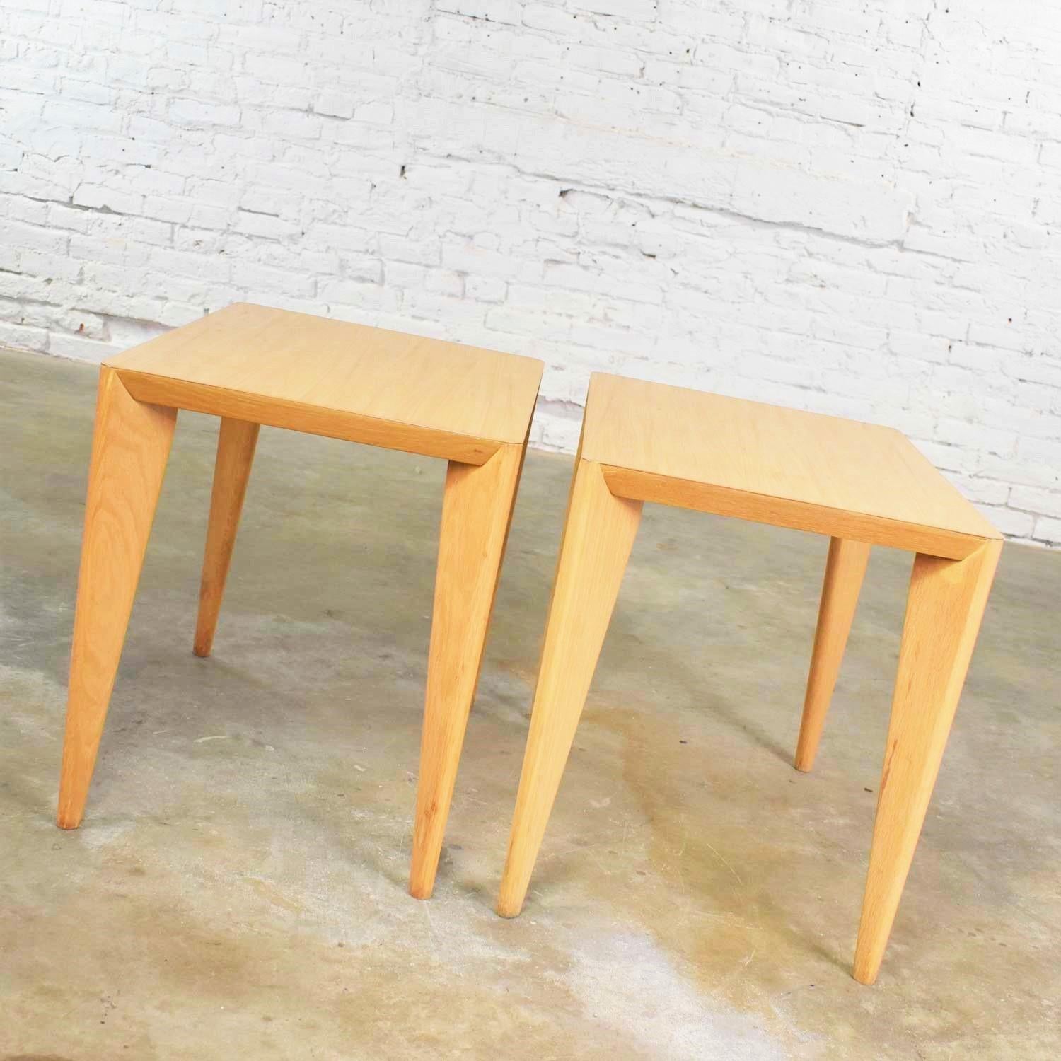 Handsome pair of blonde Mid-Century Modern side tables or end tables with light faux woodgrain laminate tops. They are wonderful restored condition although they may still have small signs of age and use. Please see photos, circa