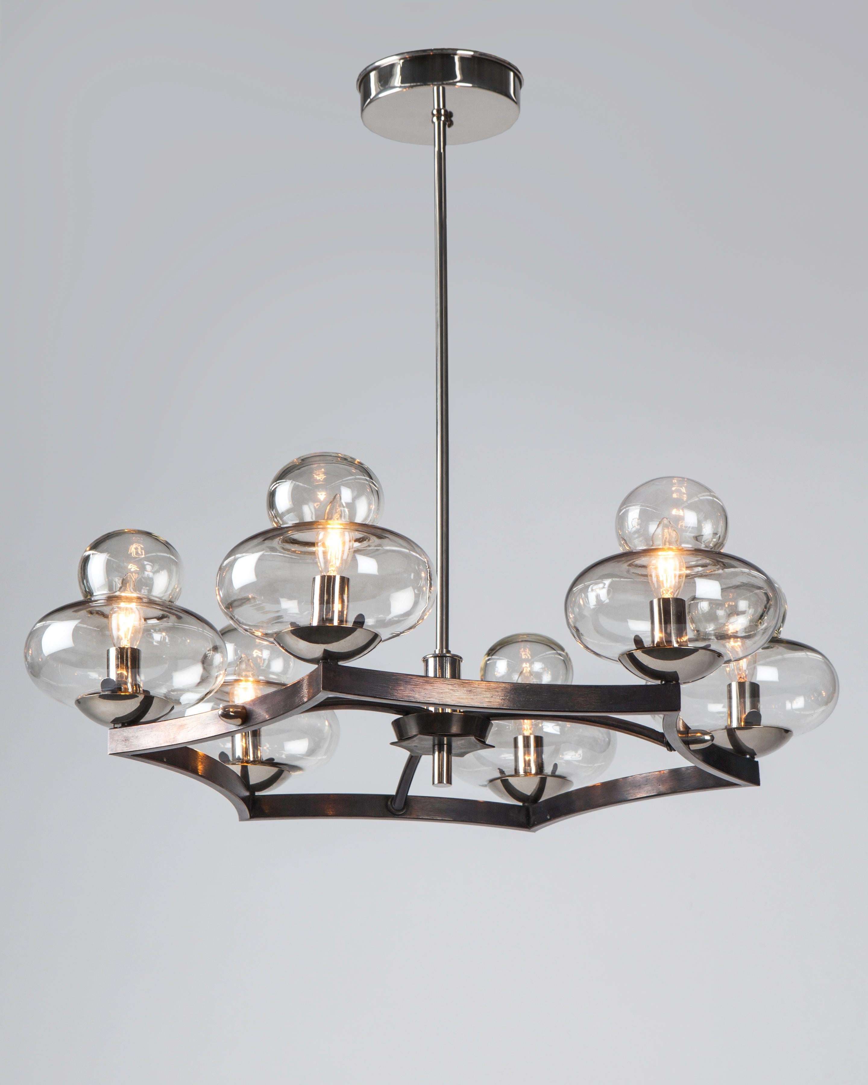 AHL4139

A six light vintage chandelier with clear glass shades arrayed at the points of a blackened metal star body. Suspended from polished nickel fittings. Circa 1950s. Due to the antique nature of this fixture, there may be some nicks or