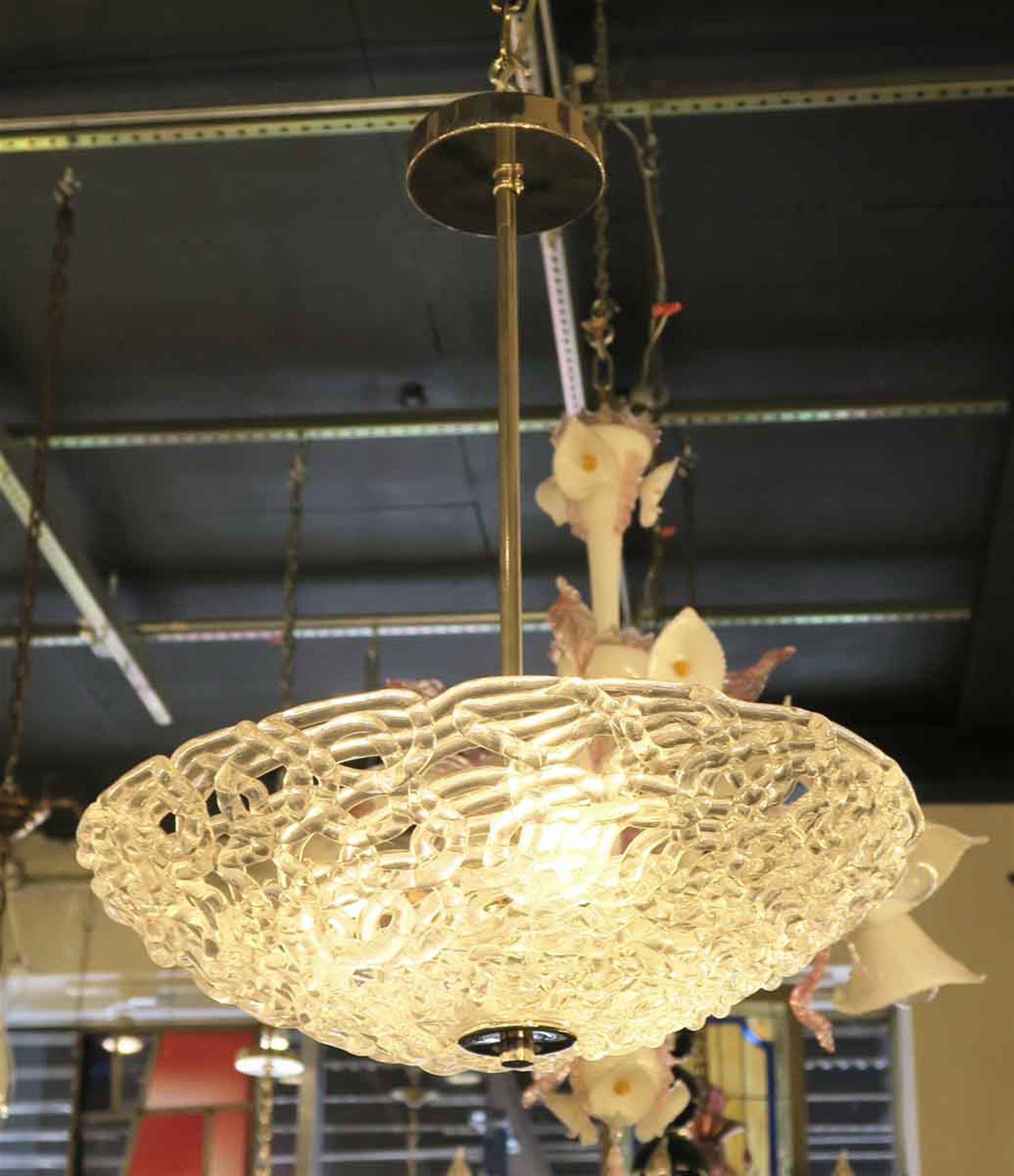 Blown glass contemporary Mid-Century Modern dish light with lattice styling with a brass fixture. This can be seen at our 2420 Broadway location on the upper west side in Manhattan.
