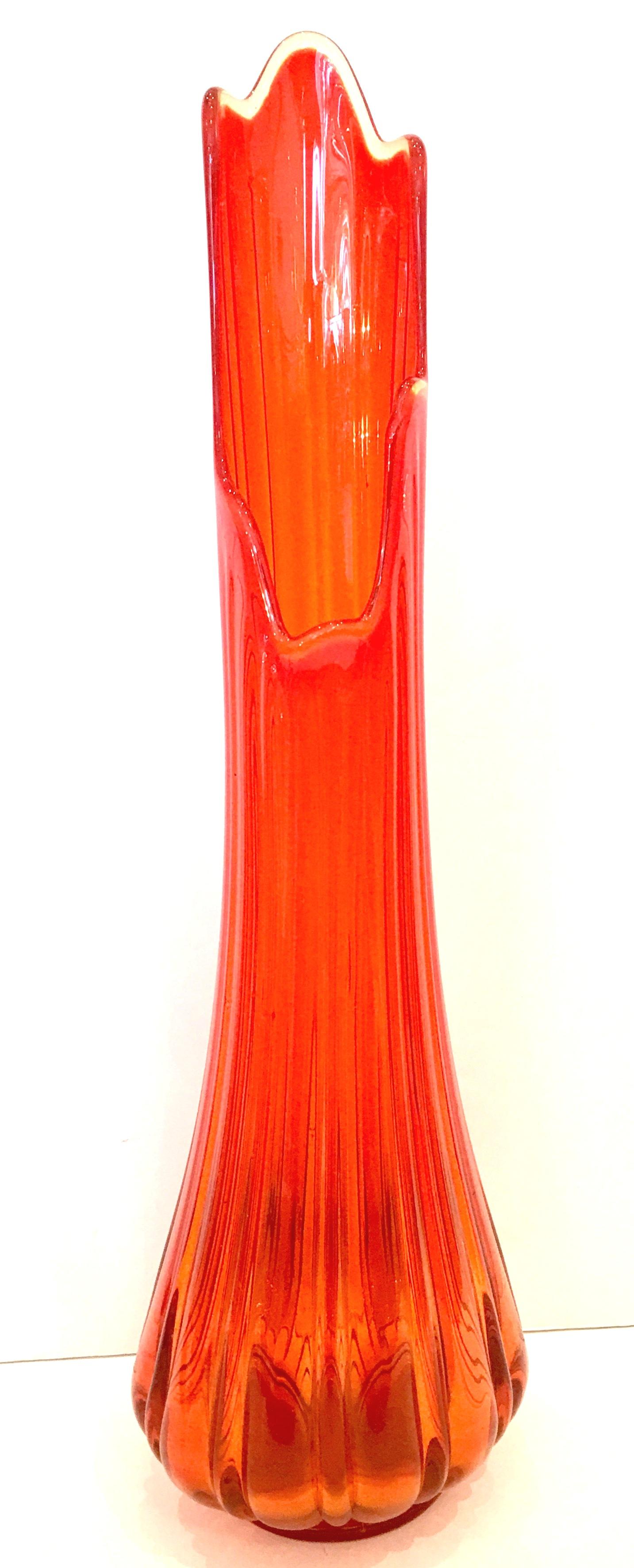 Mid-20th Century modern American blown optic art glass slag vase. Features a vivid orange fluted design and stands two feet tall. Measures: 24