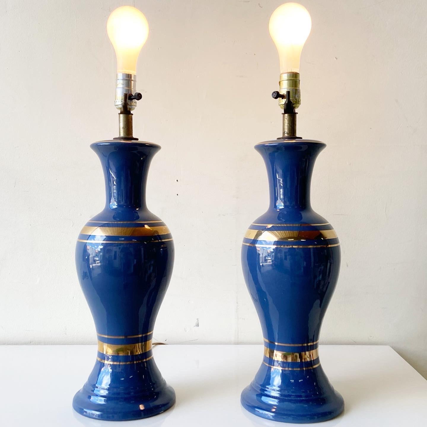 Exceptional Mid-Century Modern pair of table lamps. Each feature a blue vase with gold rings.

3 way lighting.