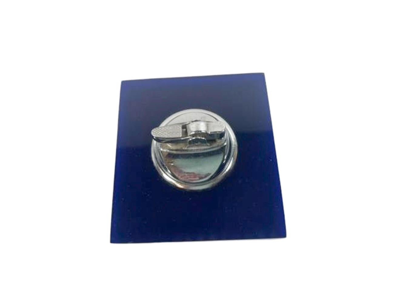 Graphic Mid-Century Modern Table lighter made of alternately stacked pieces of opaque white and translucent navy-blue Lucite with a lighter mounted in the top. Lighter mechanism marked 