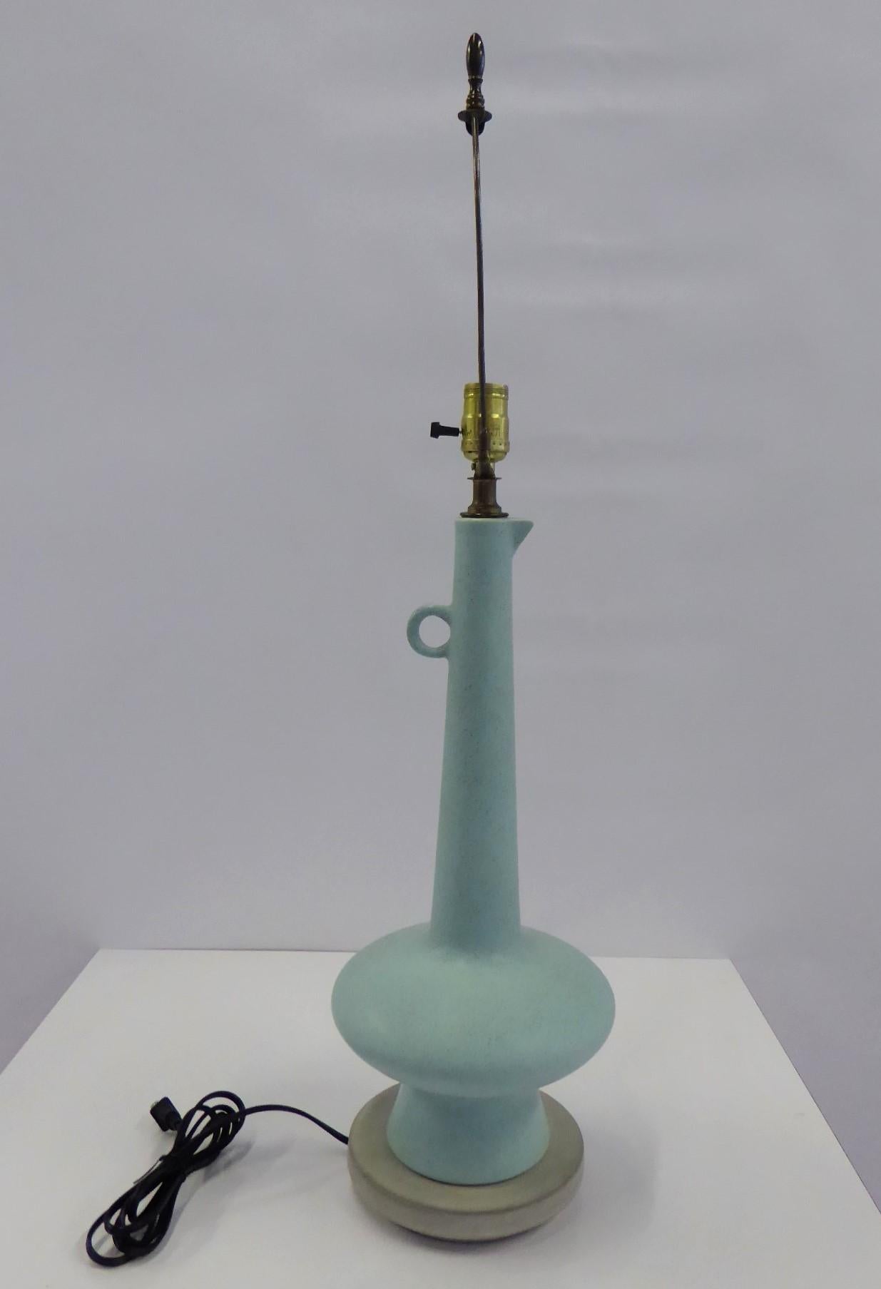 1950s ceramic table lamp pale teal aqua color with a satin finish and a pale gray base. In the shape of a long necked pitcher or ewer with a handle. Rewired with new UL 3 way socket and new cordage, ready for display. Very good condition, one glaze