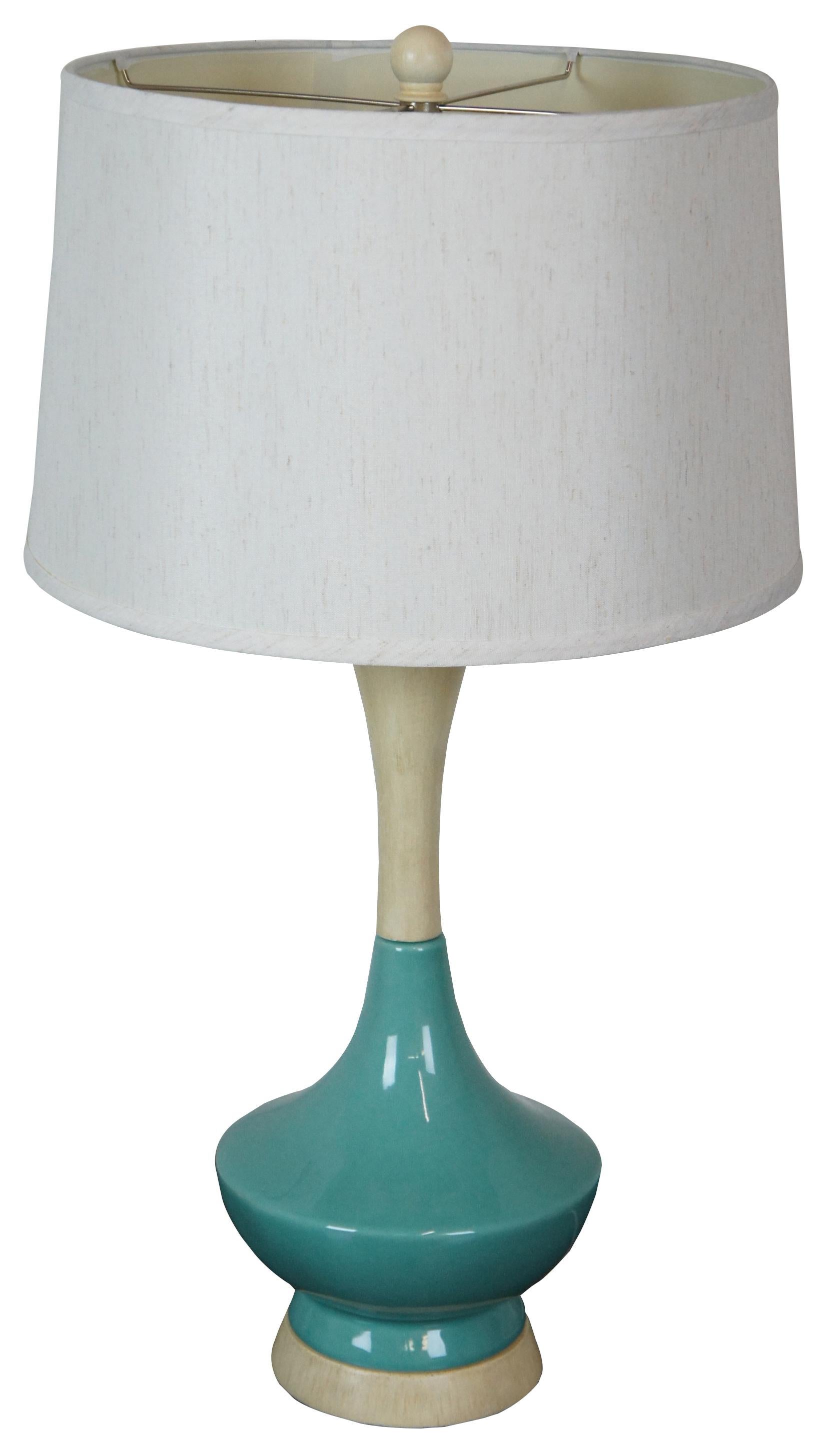 Retro or Mid-Century Modern pickled oak and robin’s egg blue ceramic table lamp.

Measures: 8.5” x 22” / Shade - 16” x 10” / Height to top of finial – 29.5” (Diameter x Height).