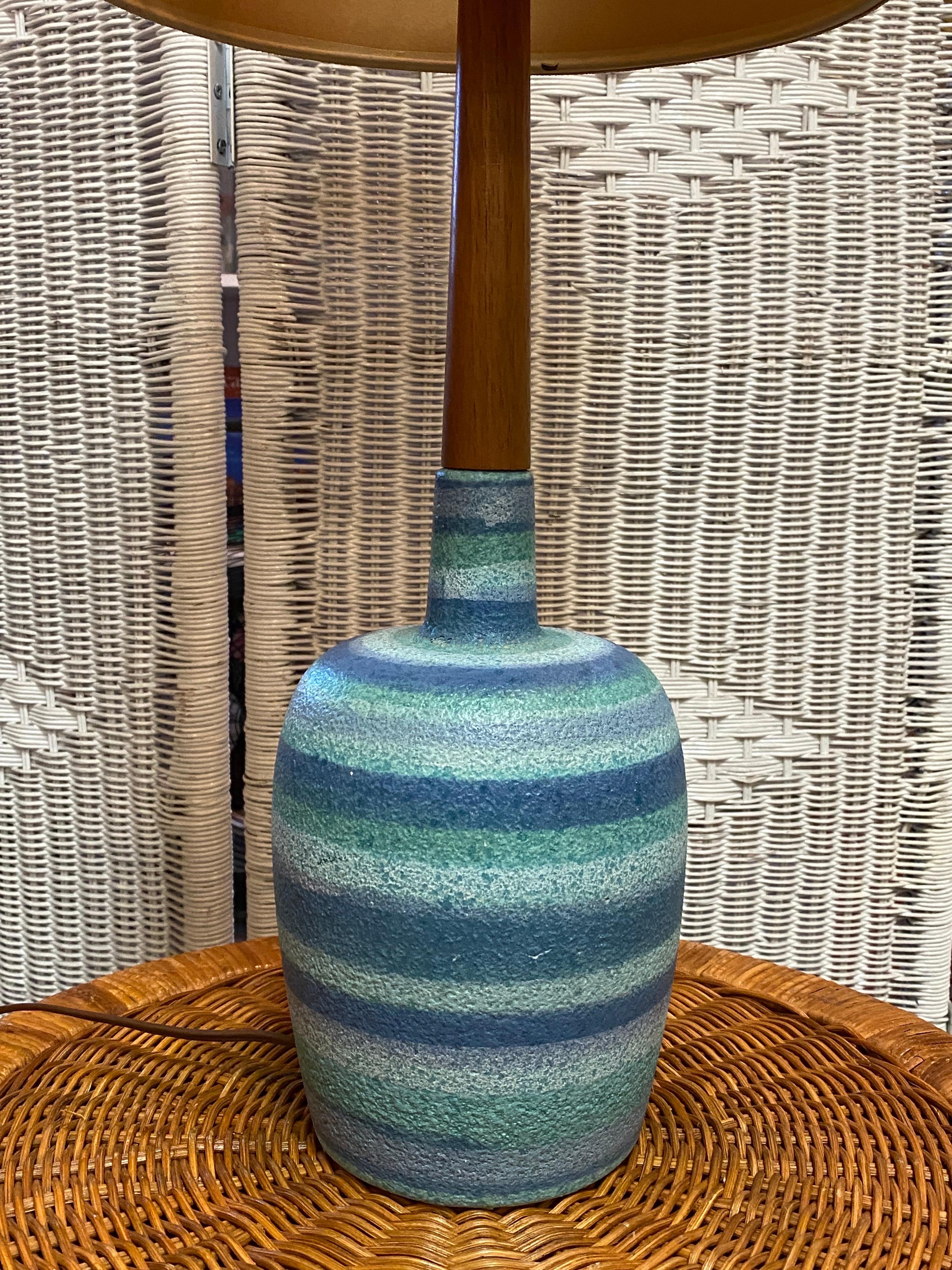 Fabulous Mid-Century Modern lamp with a turquoise striped pottery base and long slender walnut neck. This lamp comes complete with its original burlap drum shade. 

 This lamp is in overall excellent condition. This lamp works ! 

 Up to 120V