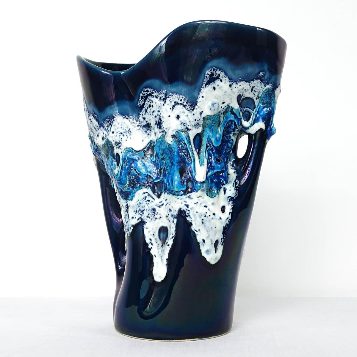 With its beautiful blue and white decor and its holes this vase by Vallauris oozes lots of character.
1950s.