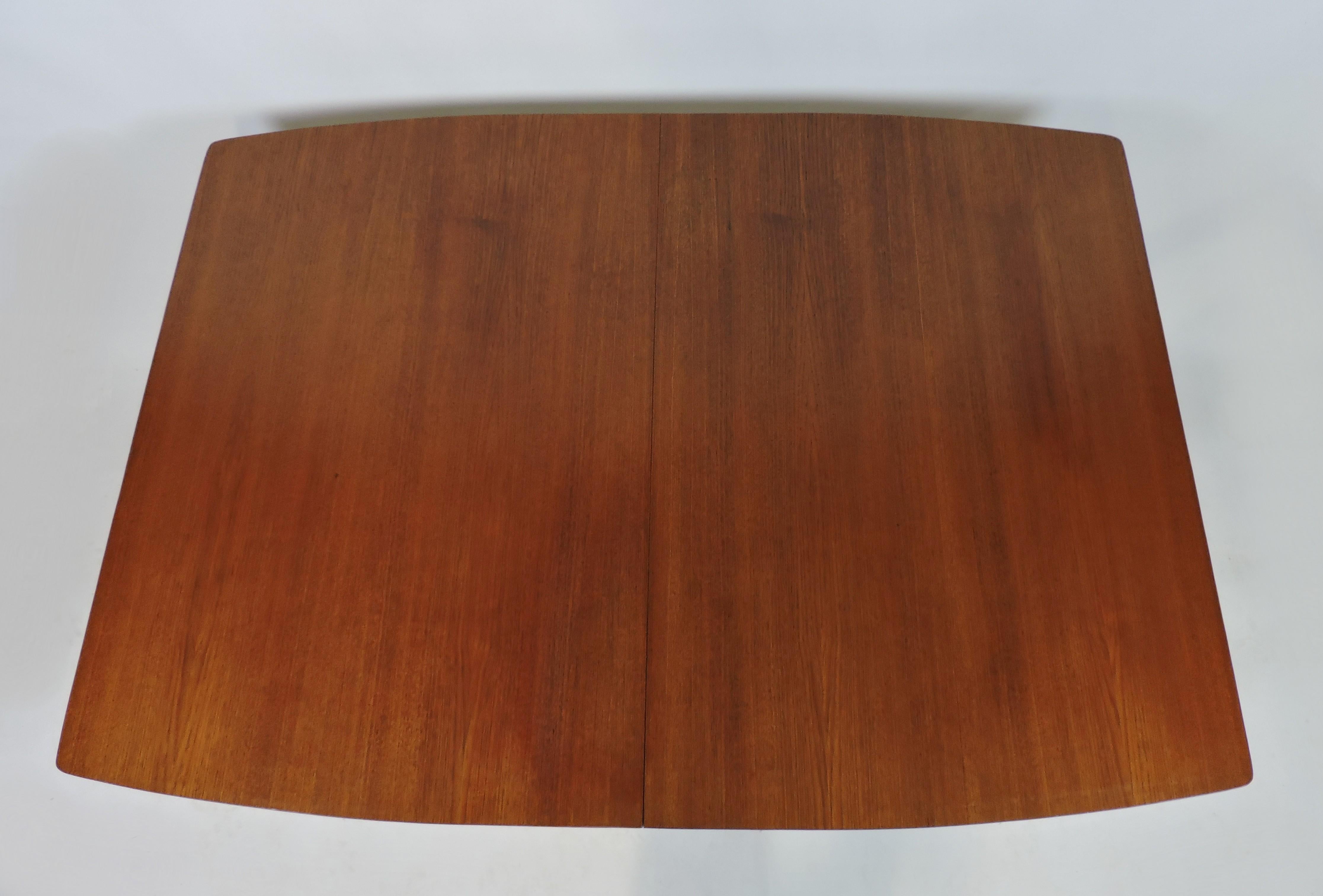 Beautiful teak Danish style dining table from the 1950s. This table has a light and airy look and can extend from 60 to 84 inches with the installation of two leaves.