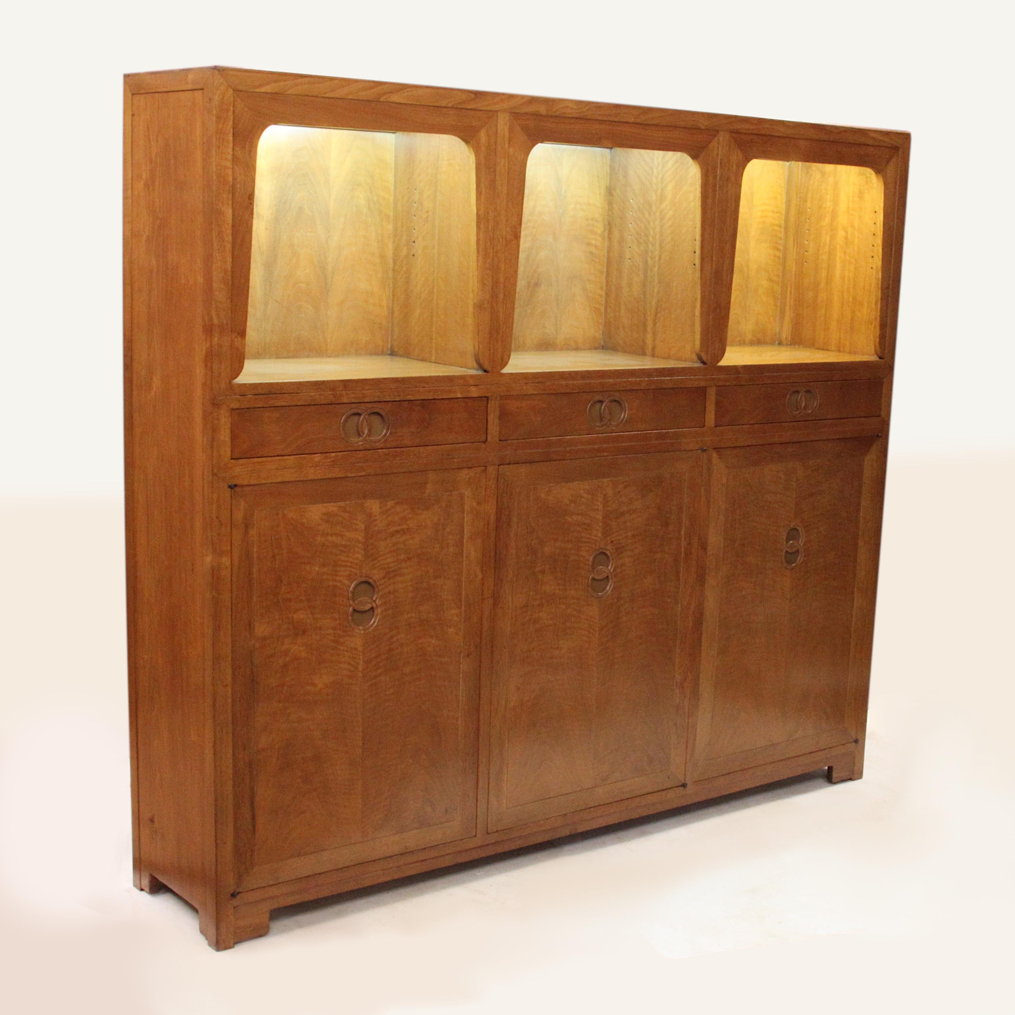 Wonderful Model 2589 Cabinet designed by Michael Taylor for Baker Furniture as part of the Far East Collection. This piece features solid walnut construction, adjustable shelves in the lower cabinet, integrated lighting in the upper cabinet, unique,