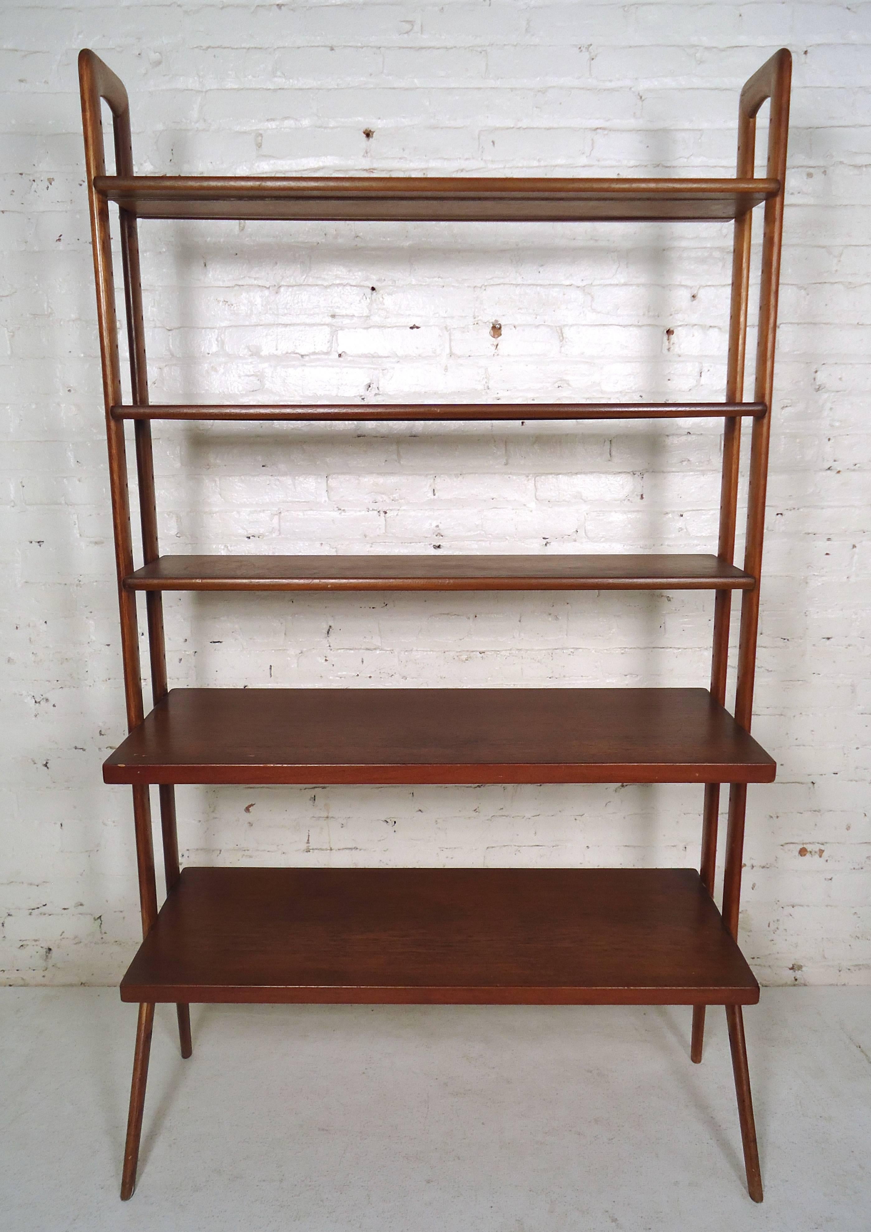 Elegant vintage modern Danish bookcase features rich teak wood grain, many shelves, and a set of sturdy legs.

Please confirm item location (NY or NJ).