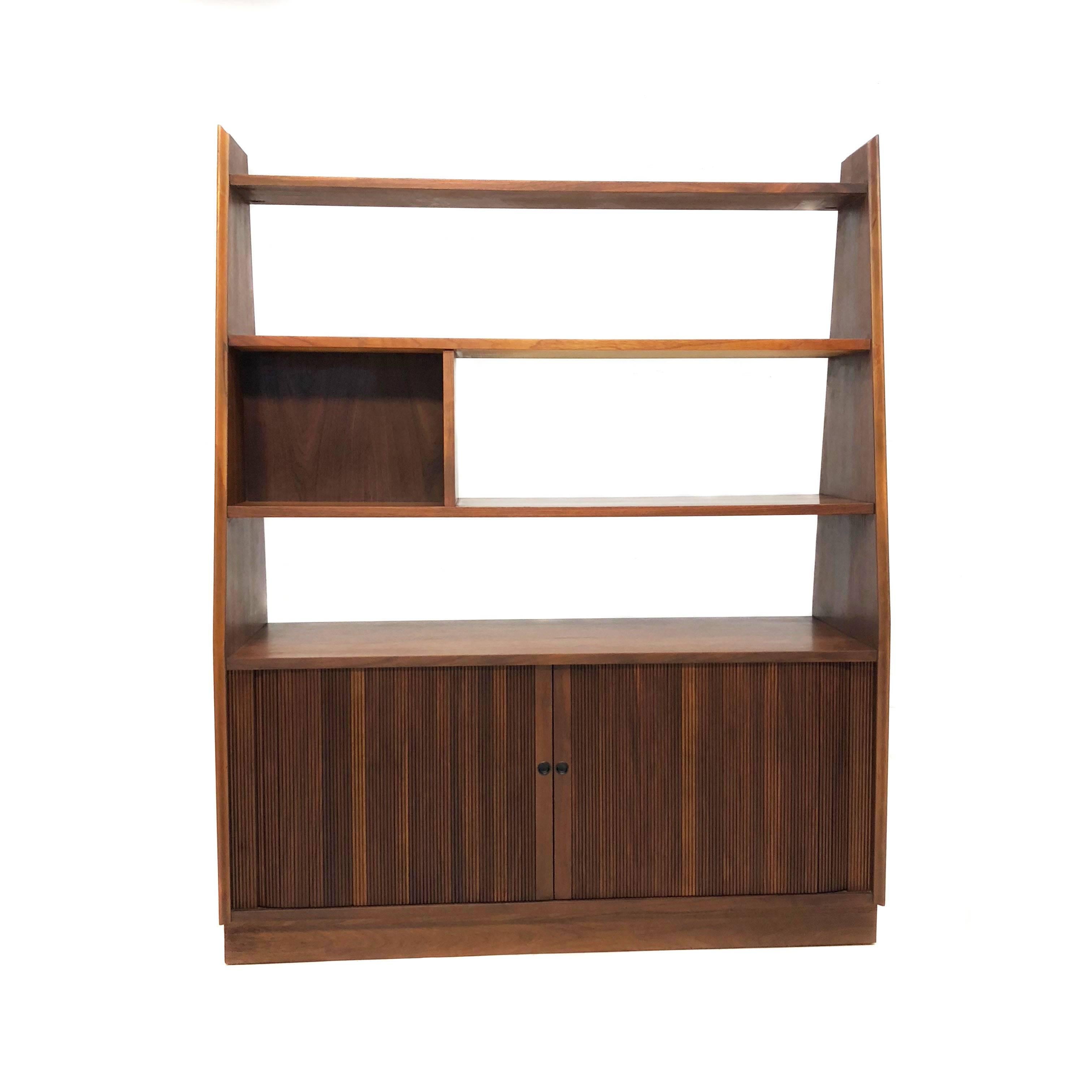Beautiful Mid-Century Modern walnut bookshelf and room divider with lower tambour door for album storage. In excellent condition with age appropriate wear.

Measurements: 48