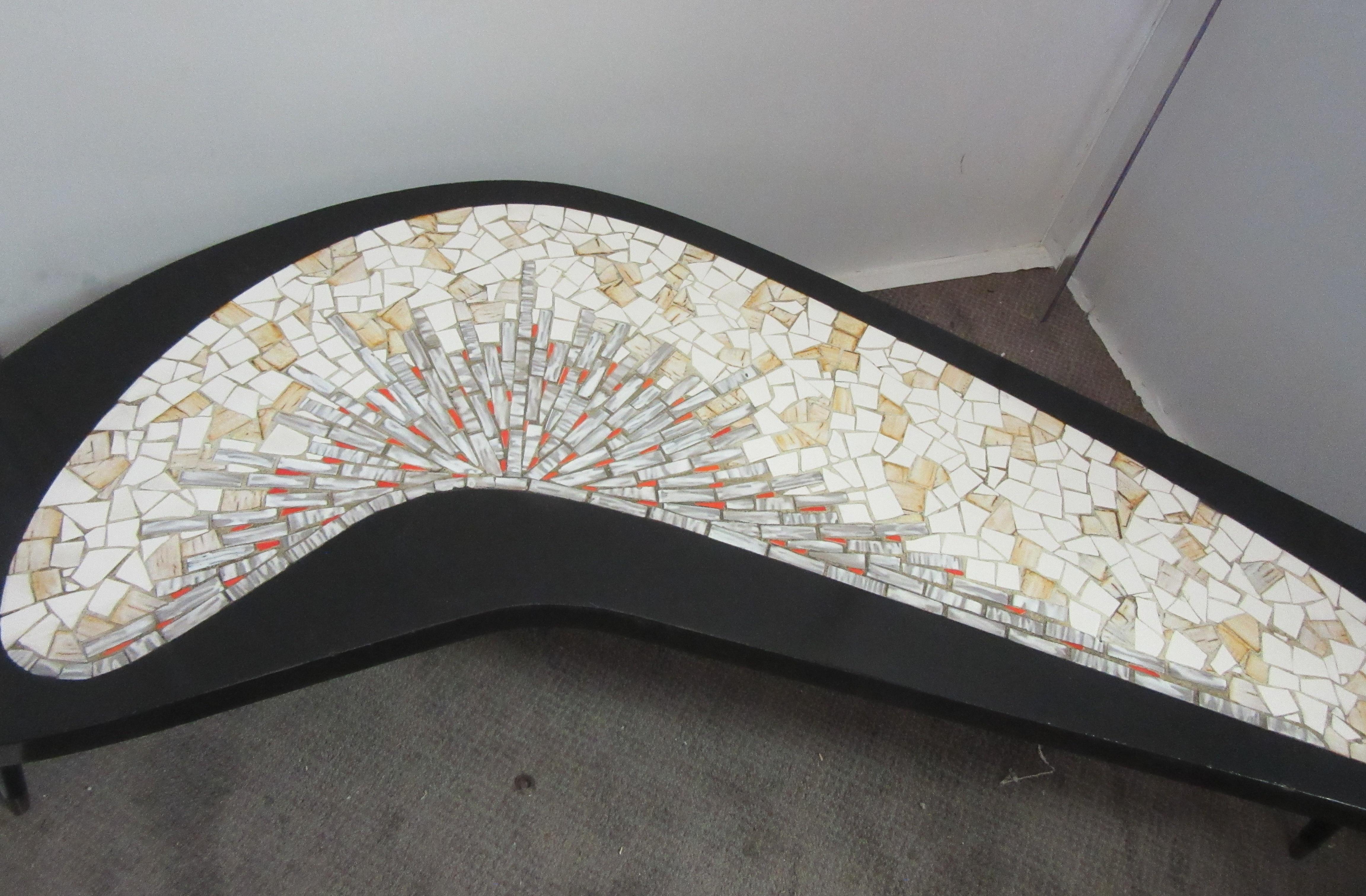 Mid-Century Modern boomerang coffee table with Mosaic tile top, made in the 1960s. The table was recently painted black and restored. tabletop has a mosaic tile top with red and yellow highlights and 3 legs. In great vintage condition with