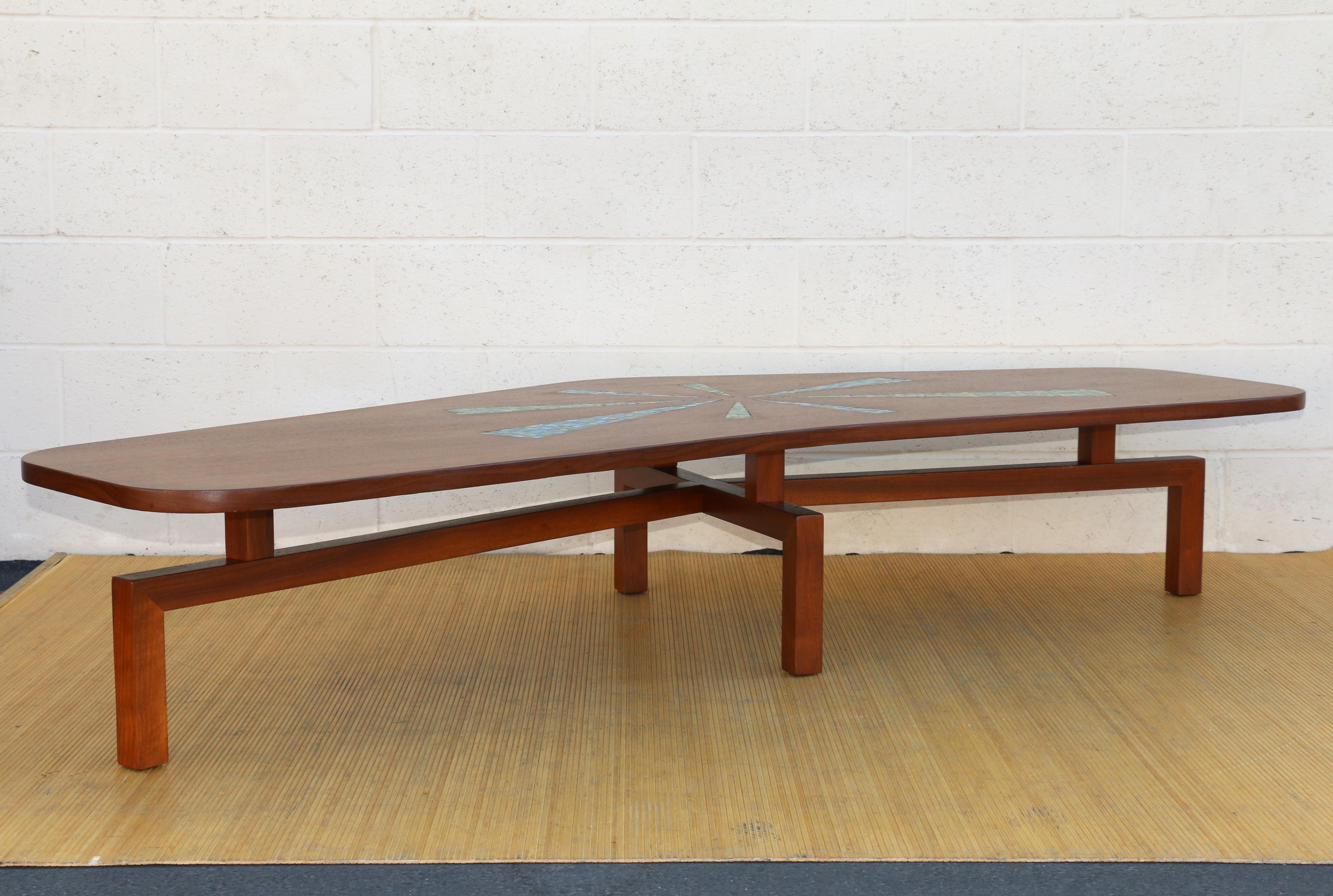 Spectacular Mid-Century Modern coffee table with mosaic top. This amazing relic is original from the 1960’s. It has an amazing boomerang shape top and  has some mosaic accents on it, this accent definitely makes it stand out from the rest. This