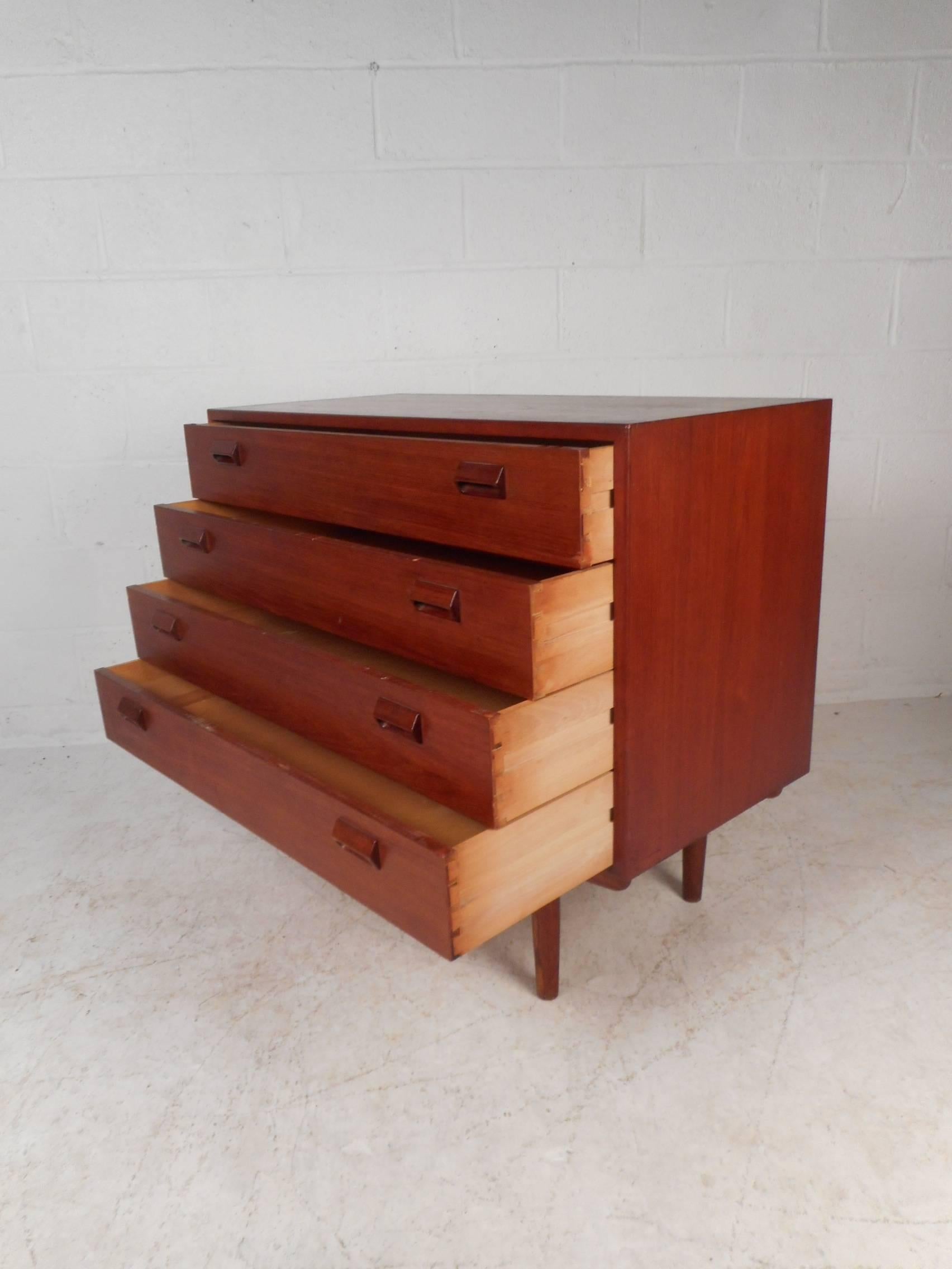 Stunning vintage modern gentleman's chest with plenty of room for storage. Sleek design with carved drawer pulls and sturdy tapered legs. Please confirm item location (NY or NJ).