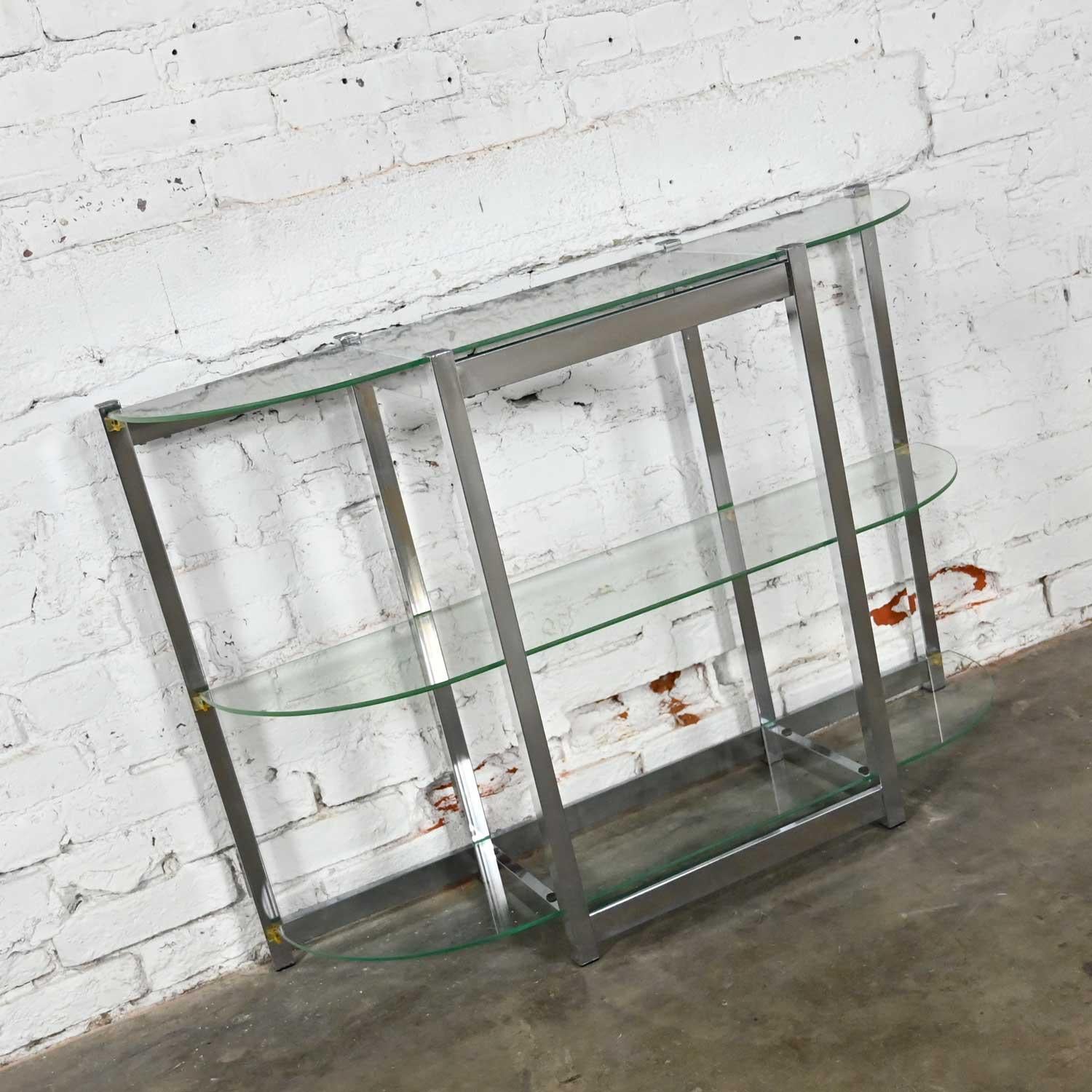 Fabulous Mid-Century Modern sofa table or console table comprised of a bow shape chrome frame and 3 bowed glass shelves. Done in the style of James David or Design Institute of America aka DIA. Beautiful condition, keeping in mind that this is