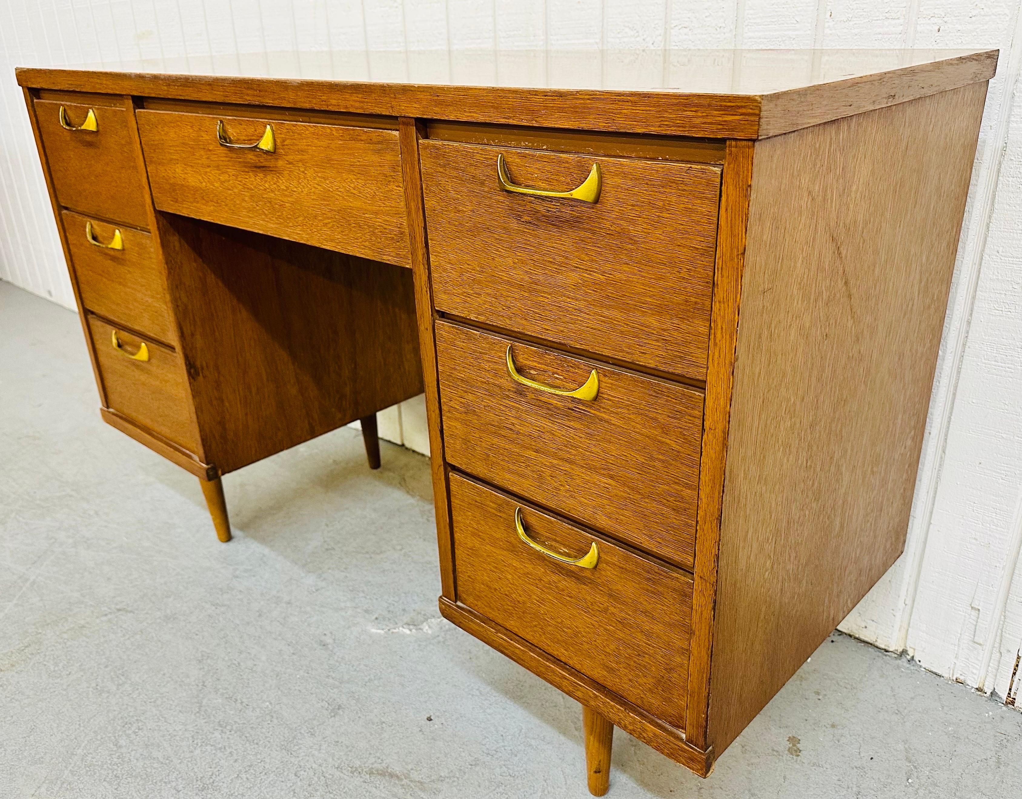 This listing is for a Mid-Century Modern Brasilia Style Walnut Writing Desk. Featuring a straight line design, rectangular protective laminated top, seven drawers for storage, and Brasilia style sculpted brass hardware. This is an exceptional