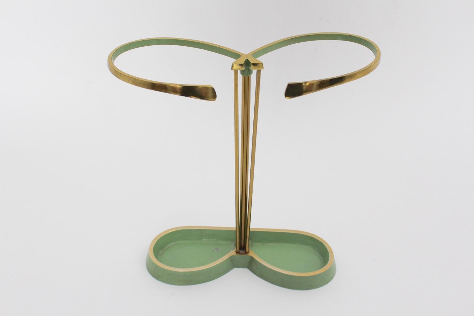 Mid Century Modern vintage umbrella from brass and cast aluminum - partly pistachio green lacquered 1950s Austria.
This stunning umbrella stand was designed and made in Austria 1950 and is in original good condition - ready to live.

approx.
